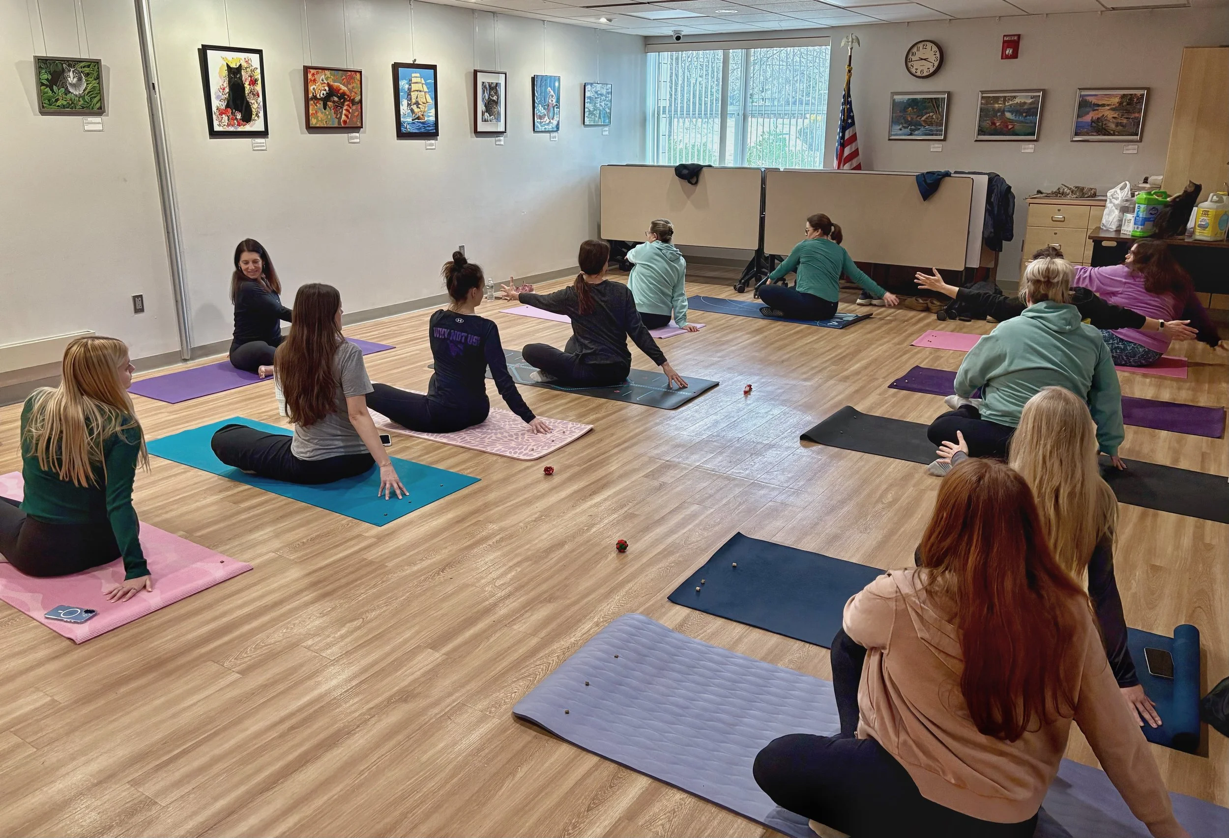 Participants practice a seated “Whisker Twist” during Cat Yoga at the Abington Community Library in Clarks Summit, Pennsylvania.