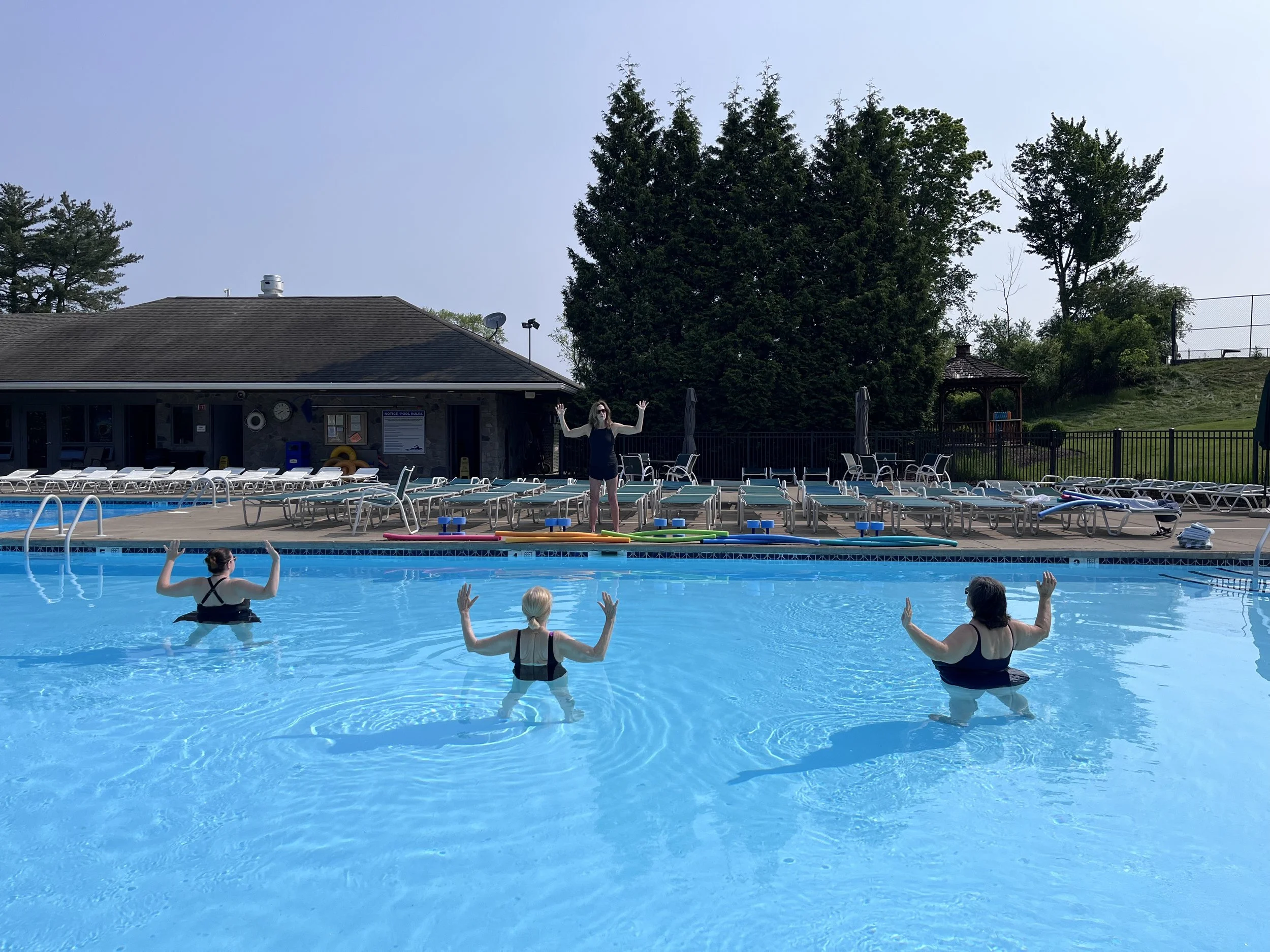 Group Aqua Yoga class in the outdoor
 pool at Glen Oak Country Club in Clarks Summit, Pennsylvania.