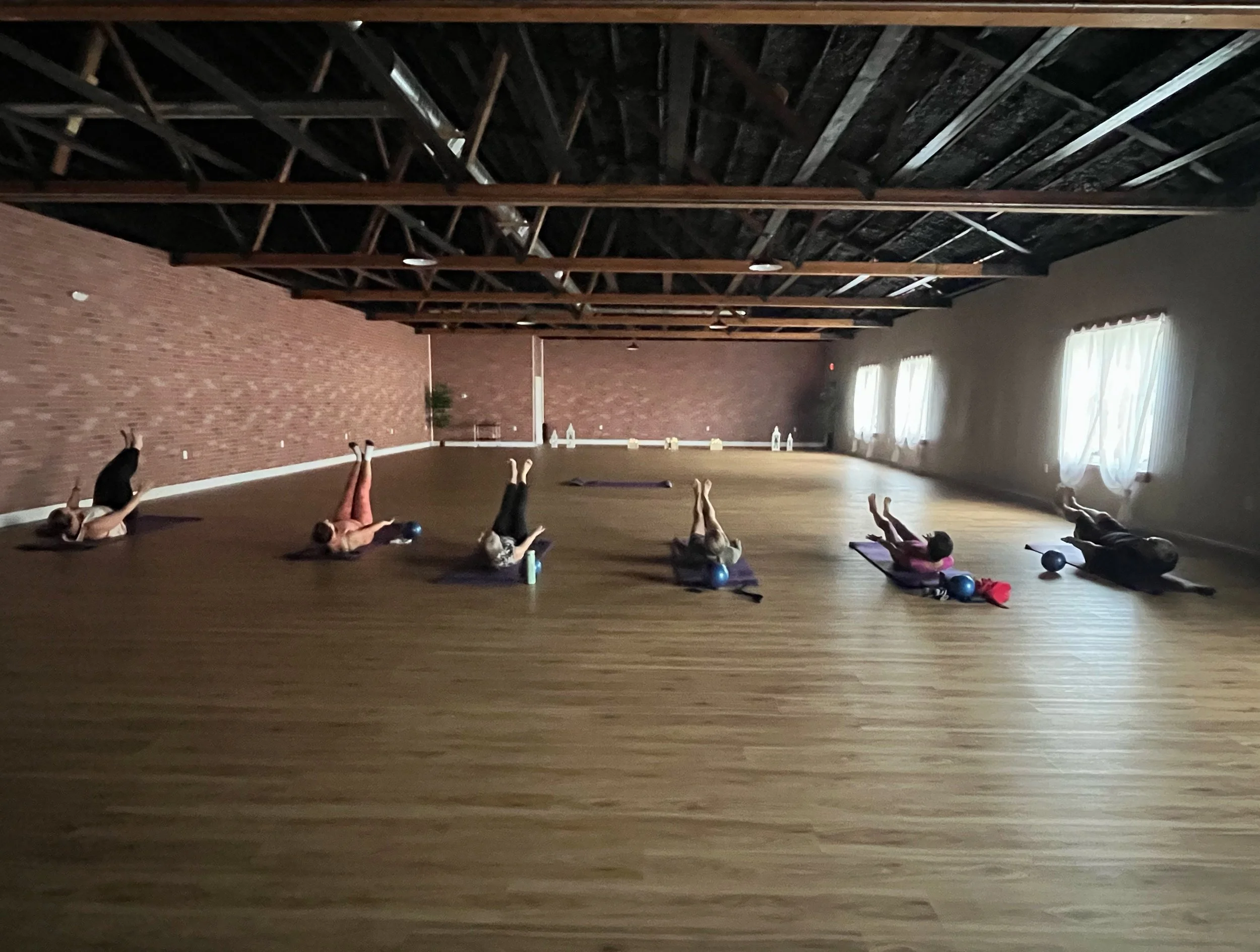 class doing Pilates 100's exercise