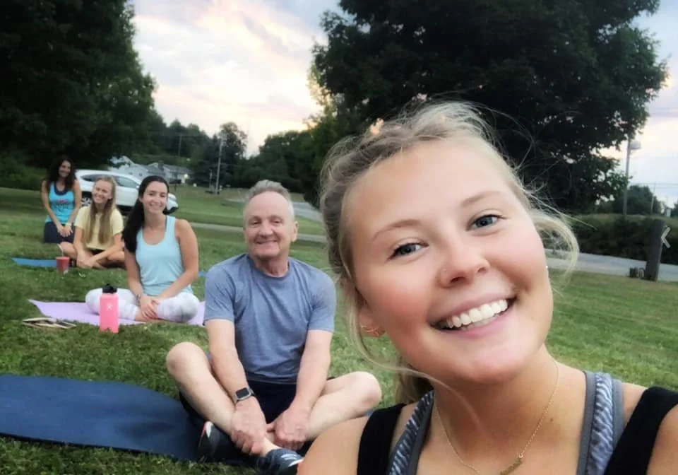 community-yoga-camelot-lawn-smiling-participants-jaya-yoga.jpg