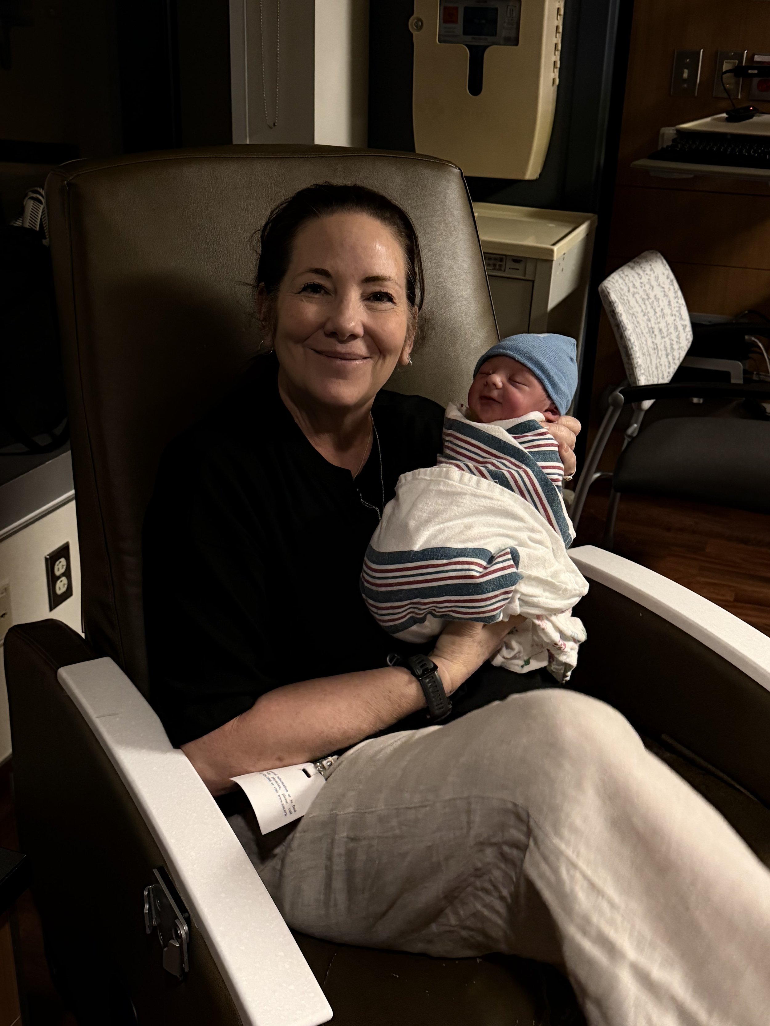 Kelly Simkowski, Lake Geneva Based doula holding newborn baby