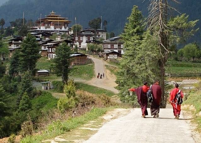 Monks walking towards Gangteng Gompa, one of the most important and historic monasteries in Bhutan.