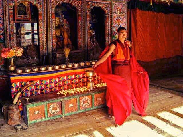 Monk adjusting his robes, Lhuentse Dzong.