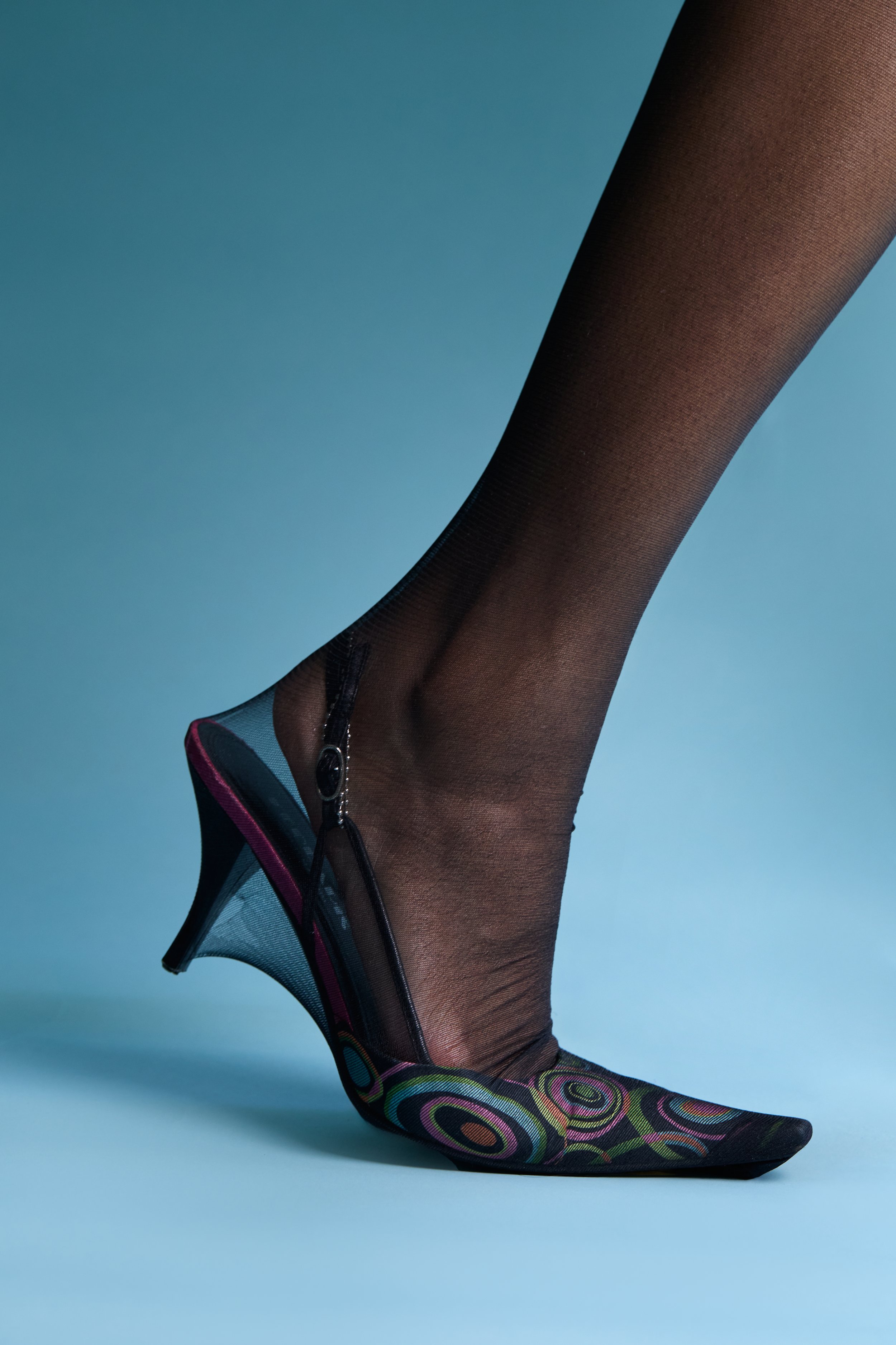 close-up of a foot stepping forward and slightly off the ground, titled “the becoming”