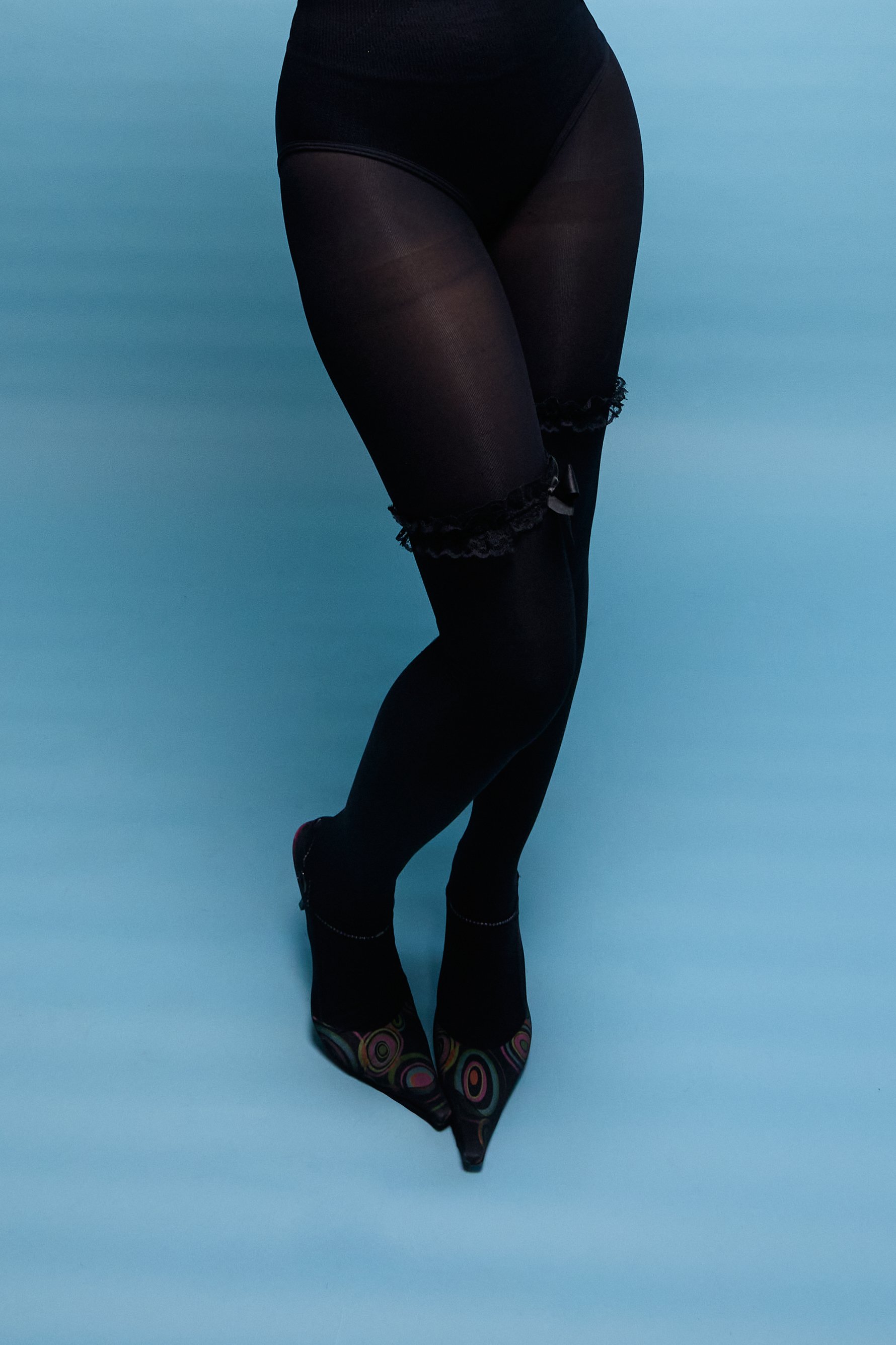 standing portrait with one knee subtly bent toward the other