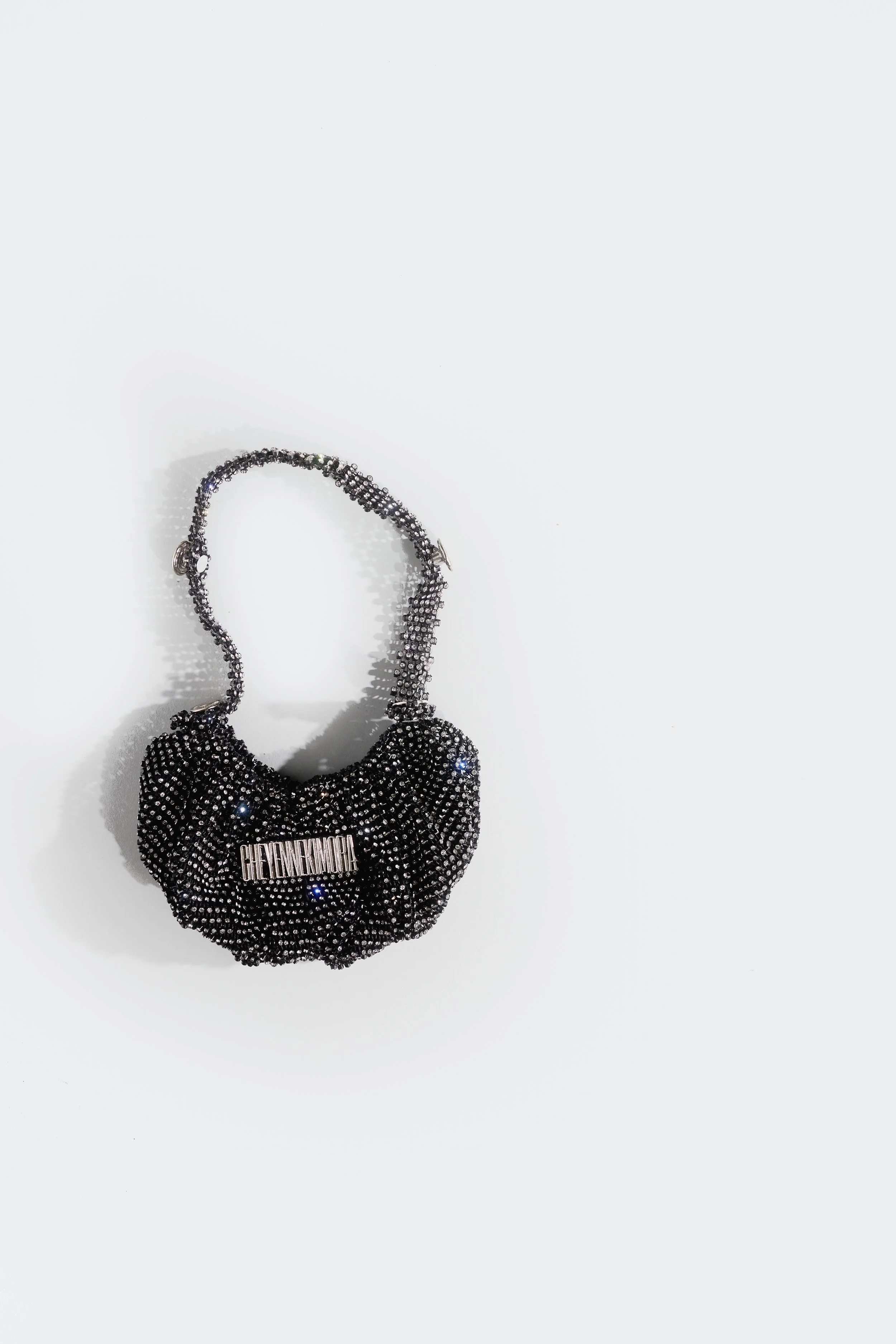 Crystal bonnet hobo bag worn close to the body, showing relaxed structure and soft form.