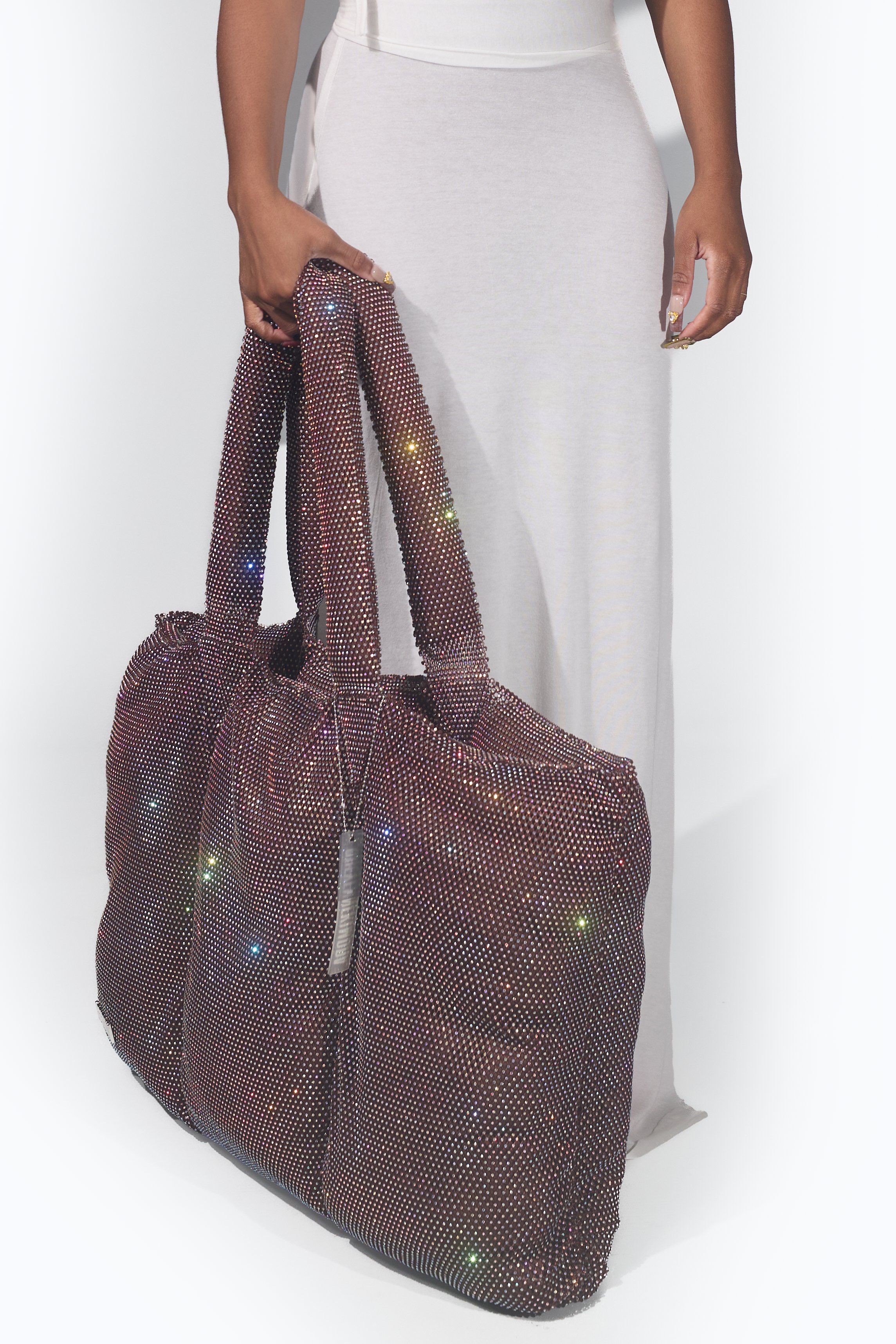 Crystal puffer bag with soft, rounded volume, photographed as a sculptural carry object against a light background.