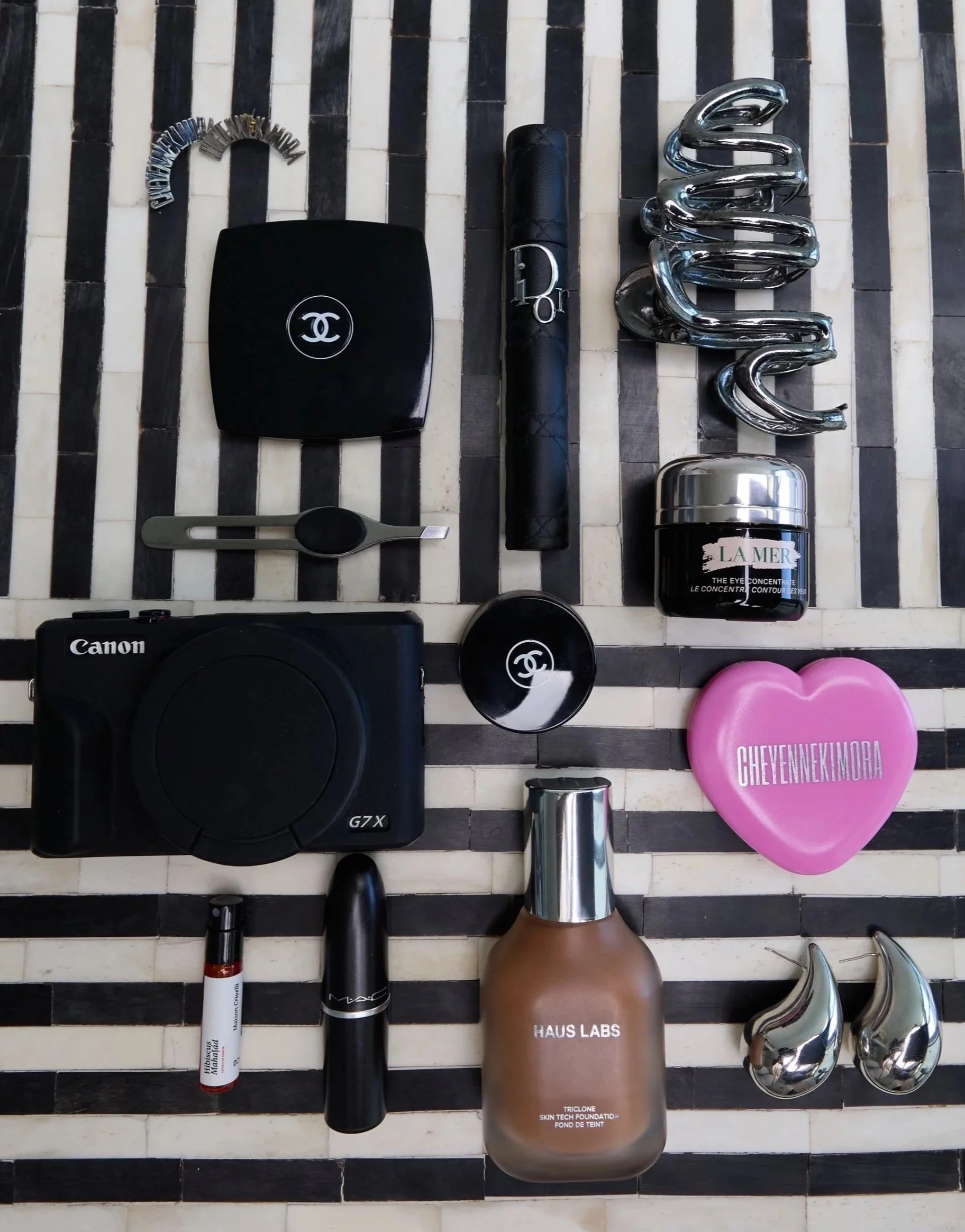 flat lay of cheyennekimora and other beauty essentials on a black and white marble table.