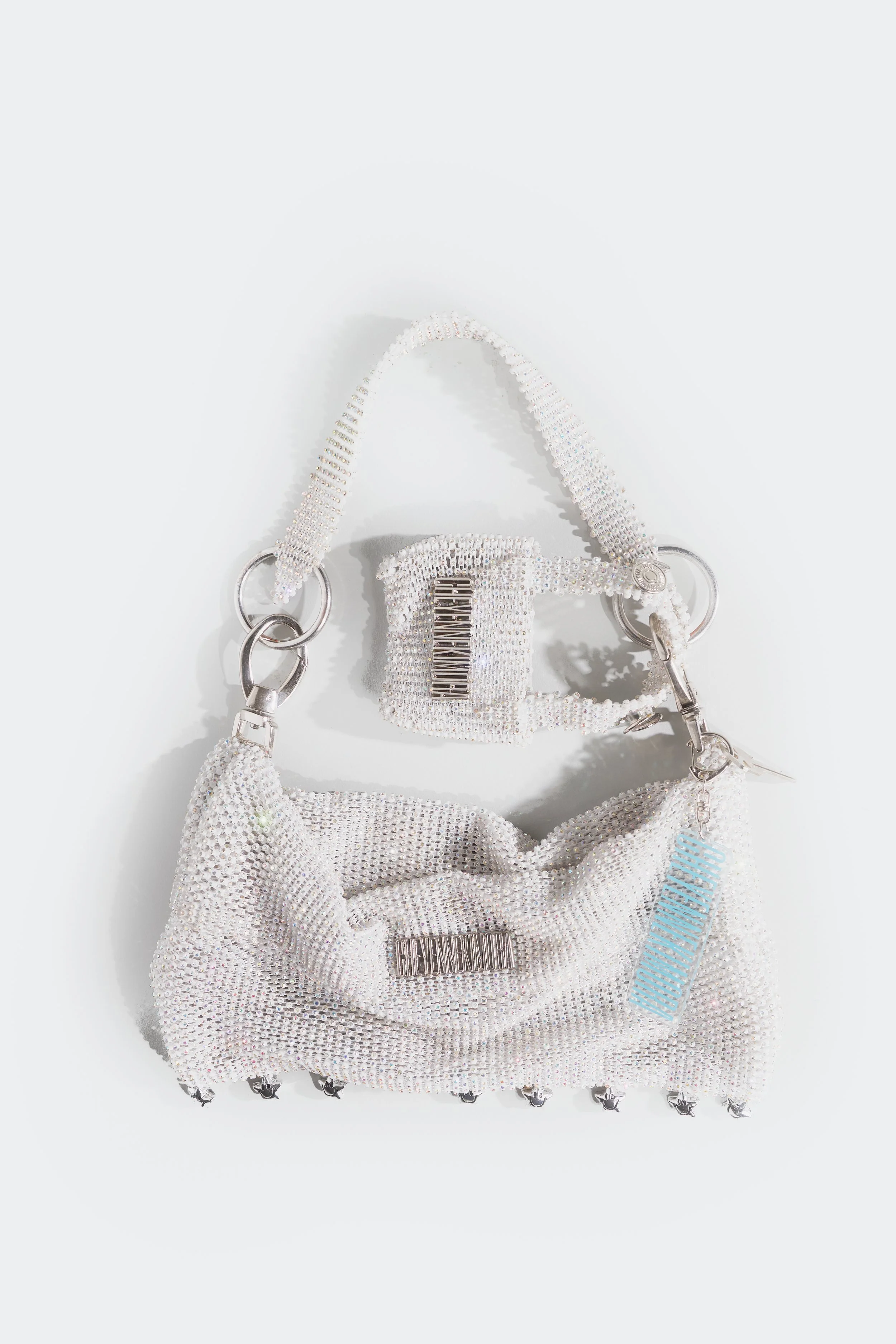 Crystal baguette shoulder bag with soft structure and metallic hardware, photographed in studio light.