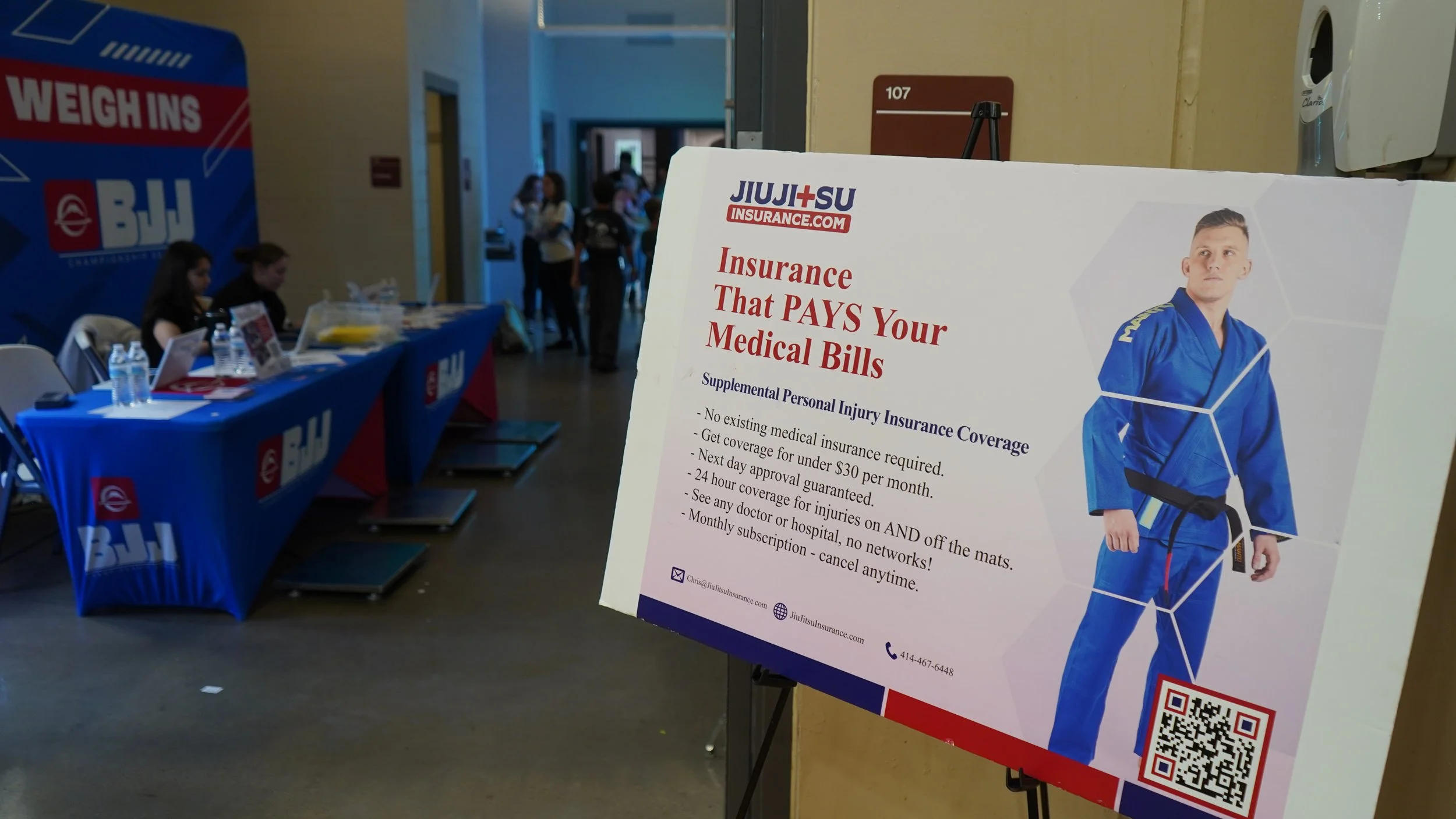 JiuJitsuInsurance.com banner at Fuji BJJ tournament promoting accident injury insurance for martial artists
