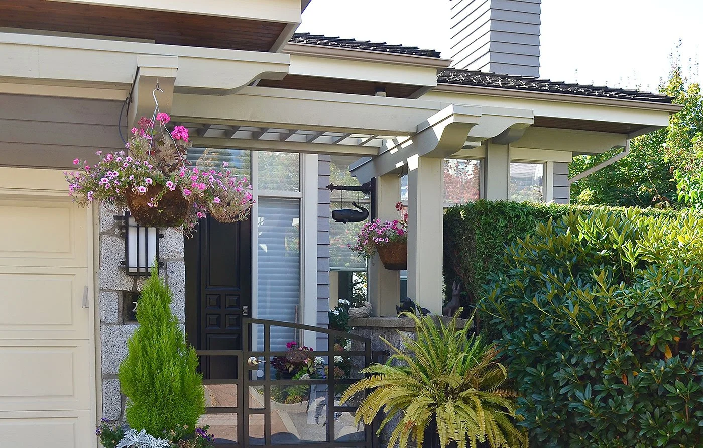 A palette of soft neutrals and warm accents creates a cohesive exterior for this multi-unit development, complementing the architecture, wood details, and abundant landscaping while giving each home a sense of character.