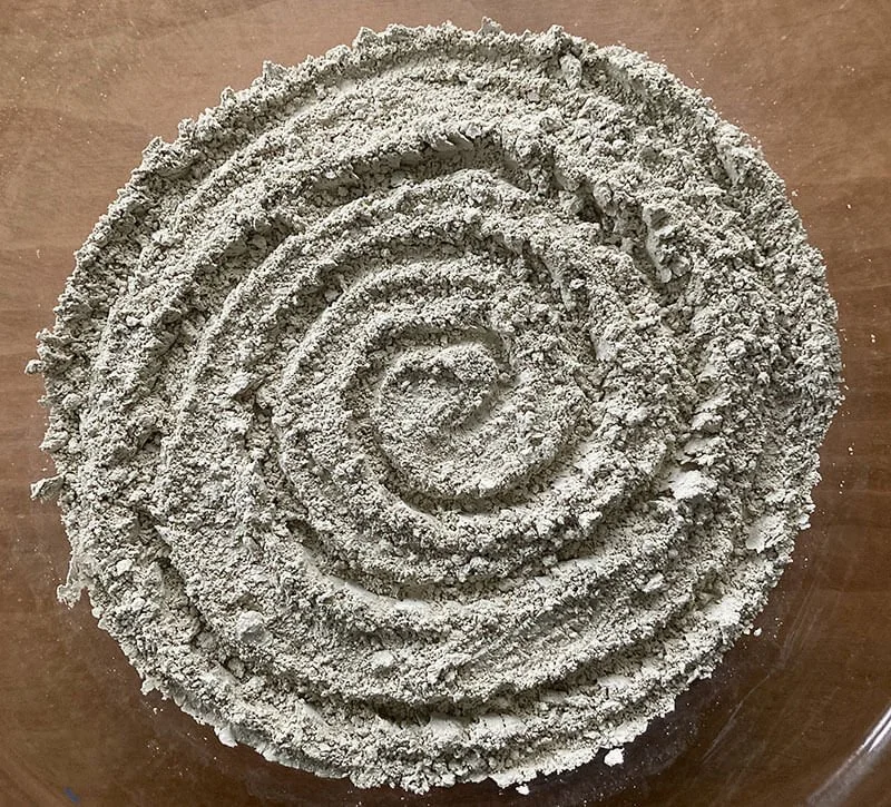 Fine particle clay powder with spiral drawn within it