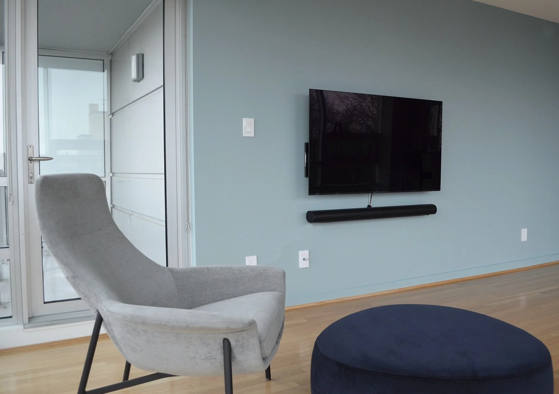 Interior of living room with blue walls and grey chair | Benjamin Moore paints Silken Blue | K Colour Design