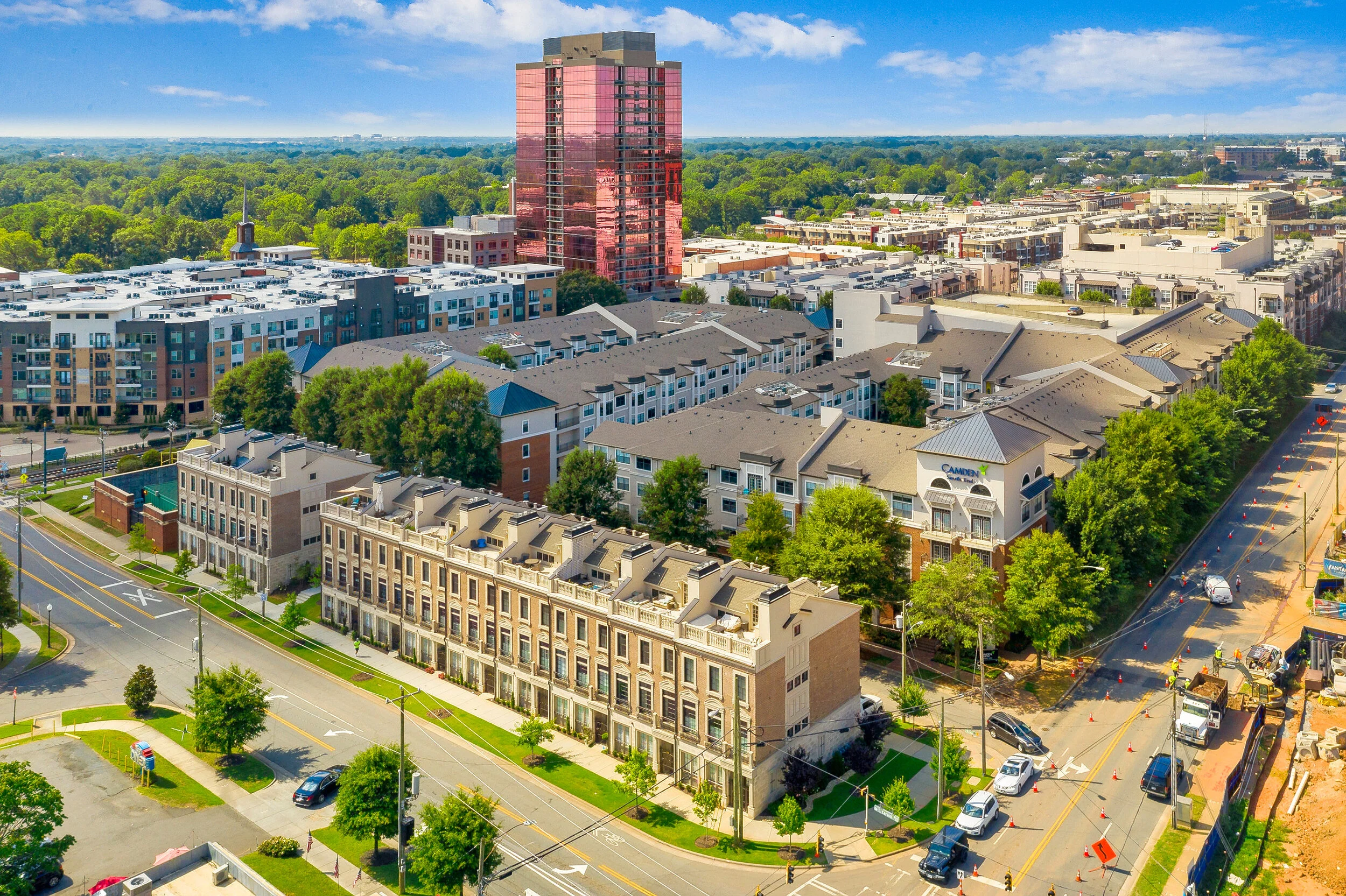 Aerial city view with mixed-use buildings and trees