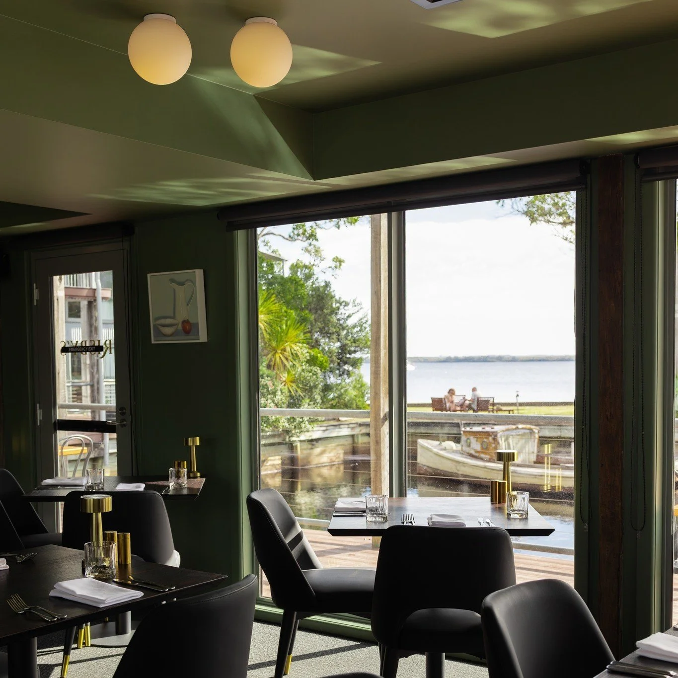 Our tables are Tasmanian oak, charred and sealed by hand &mdash; no two the same, made for Risby's. The restaurant sits right on the water, with floor-to-ceiling glass onto Macquarie Harbour.

The menu is Tasmanian seafood and produce from across the