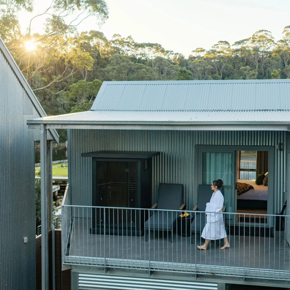 Meet our Panorama Suite.

One deck looks across the marina to Macquarie Harbour and the West Coast sunsets. The other has its own private sauna, looking into the rainforest canopy over nearby Botanical creek, where a platypus is sometimes seen foragi