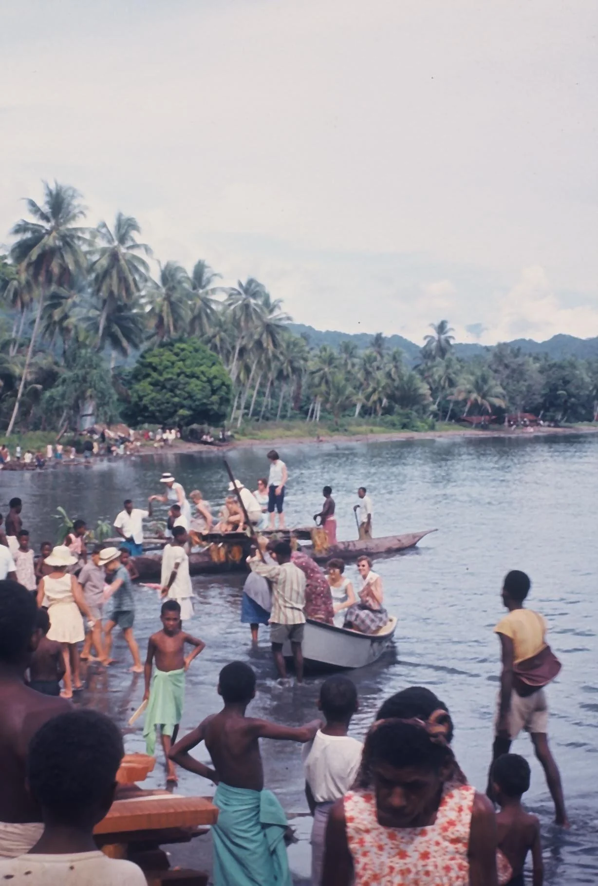 1962 People off the Victor from Lae for the Church dedication. unloading near the boathouse with Buacup to right in background..jpg