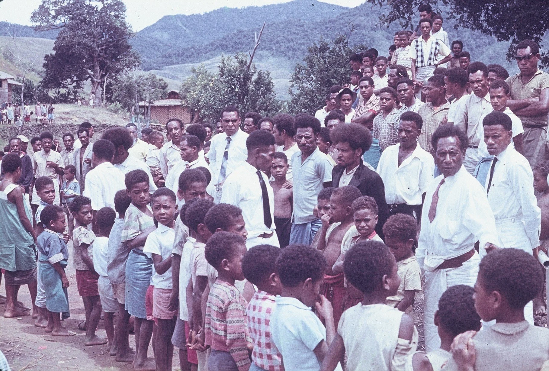 Pastor Onesimus in the middle at a Mountain village in the Malalo circuit..jpg