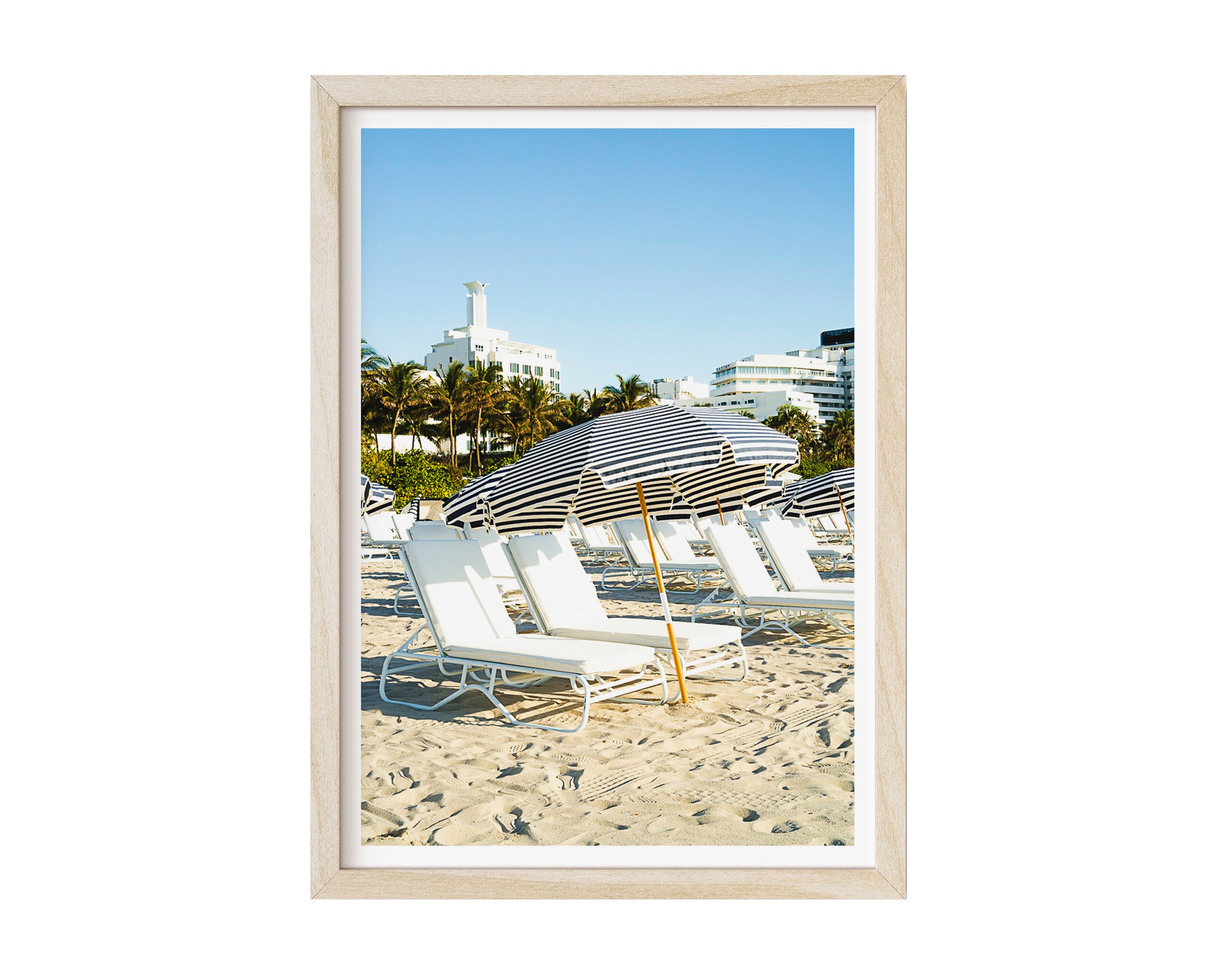 This minimalist beach scene captures architectural repetition and tranquil resort vibes, perfect for modern decor, coastal interiors, or photography collectors seeking serene, geometric compositions.