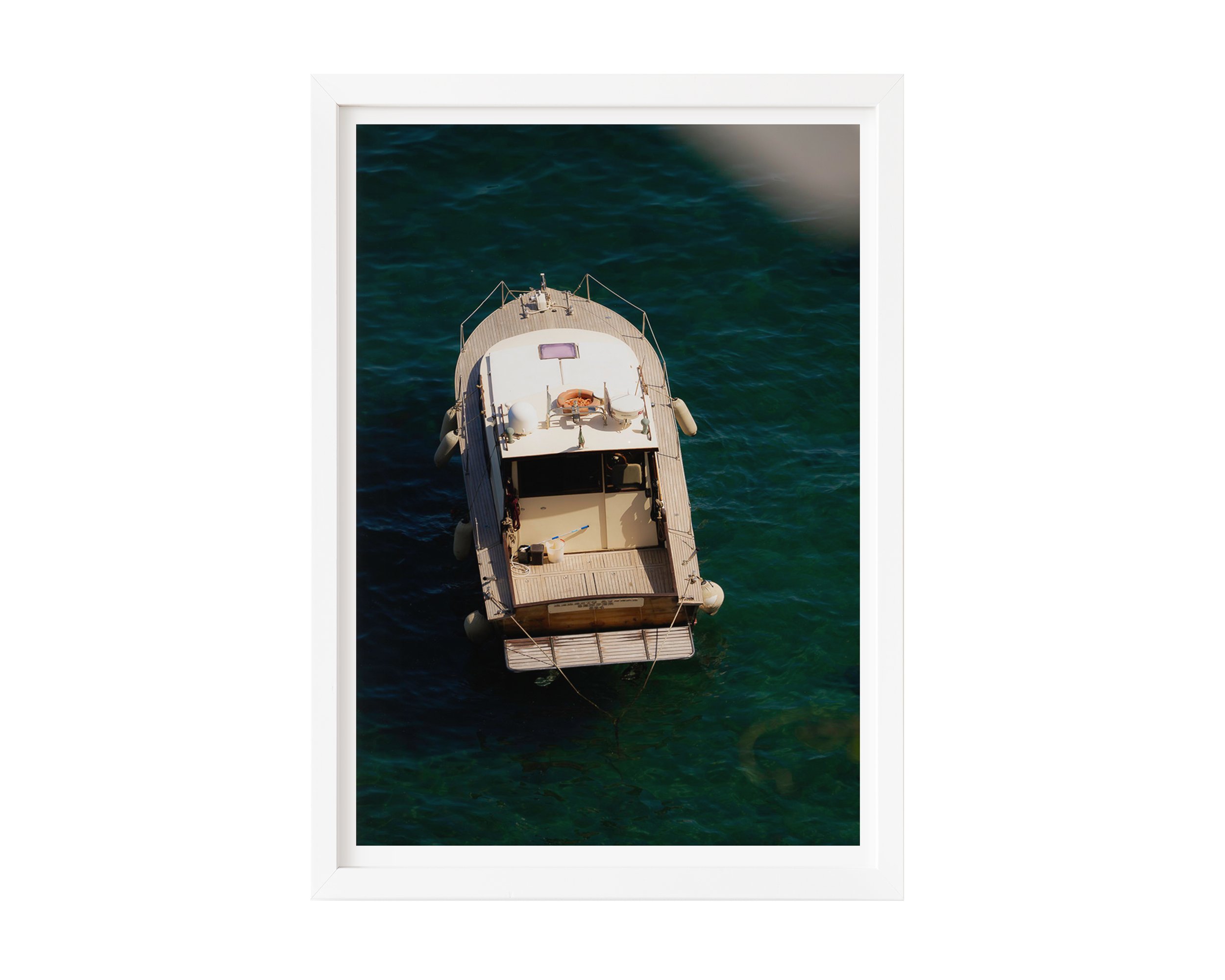 Overhead view of a vintage wooden boat floating in clear turquoise water along the Mediterranean coast, captured in golden sunlight – serene nautical fine art print by Nicole Toland Photography