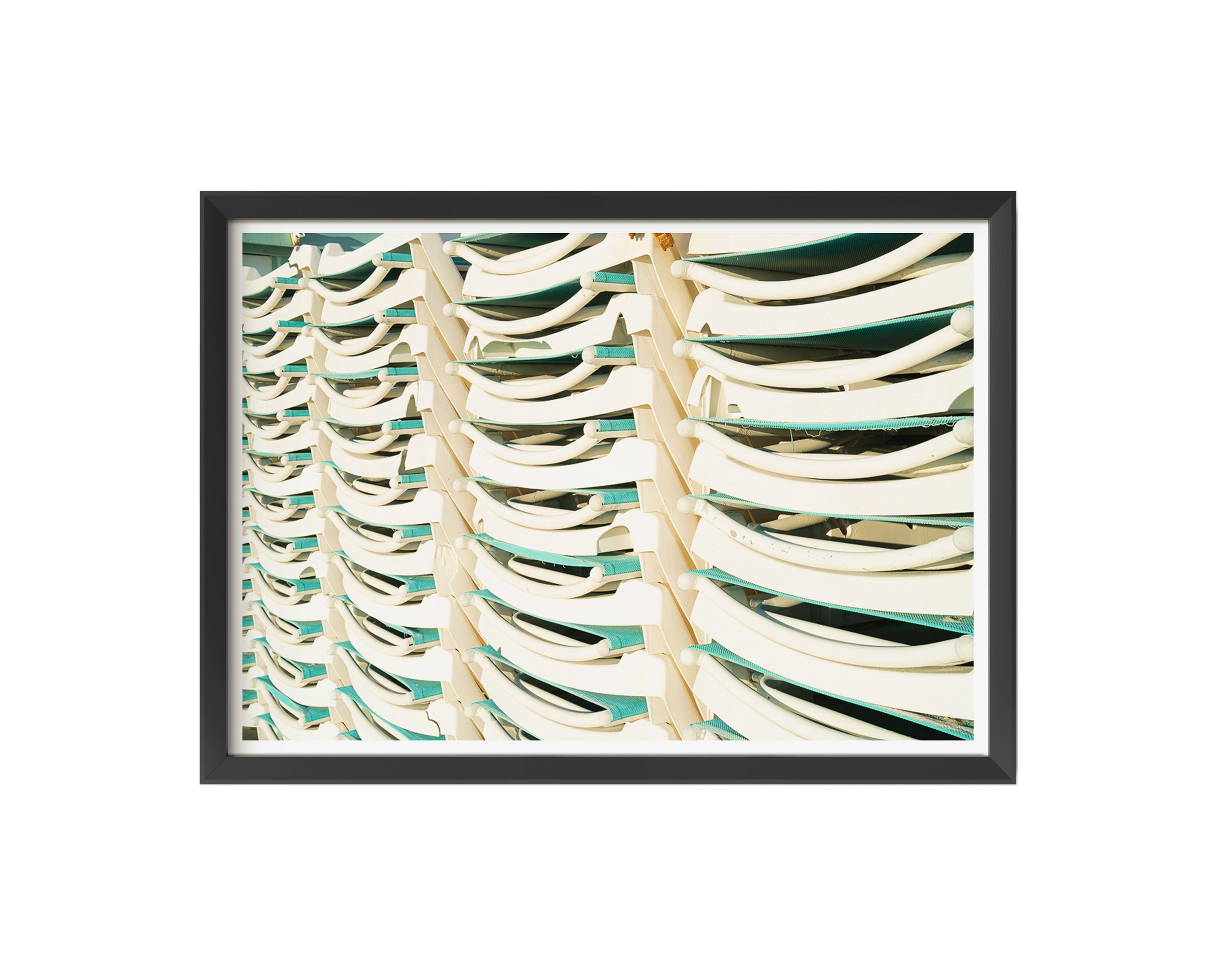 A minimalistic and playful framed fine art print featuring stacked white and teal lounge chairs, bathed in natural sunlight.
