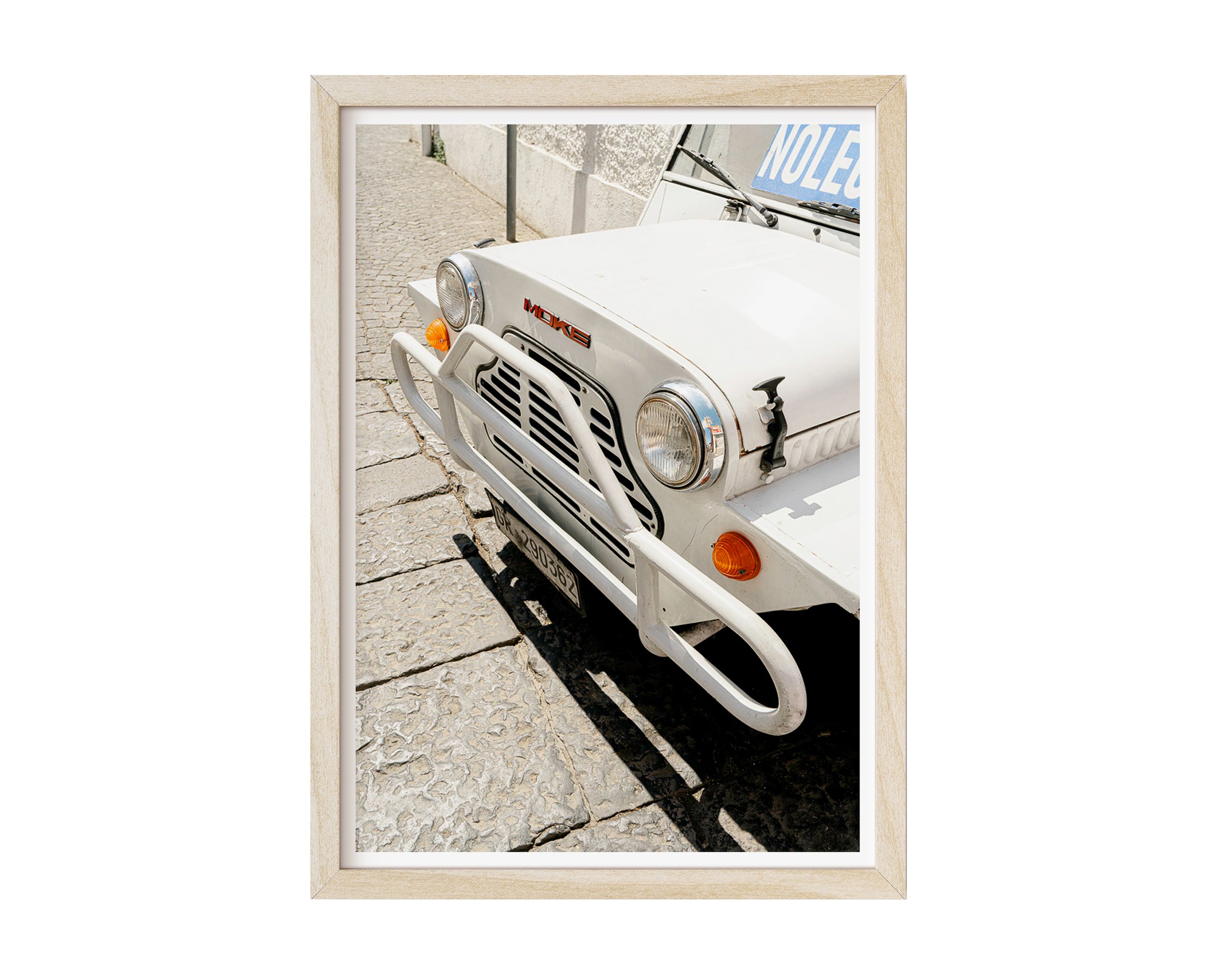Close-up of vintage white Moke car parked on sunlit cobblestone street in Southern Europe, captured in golden daylight – retro travel photography print by Nicole Toland