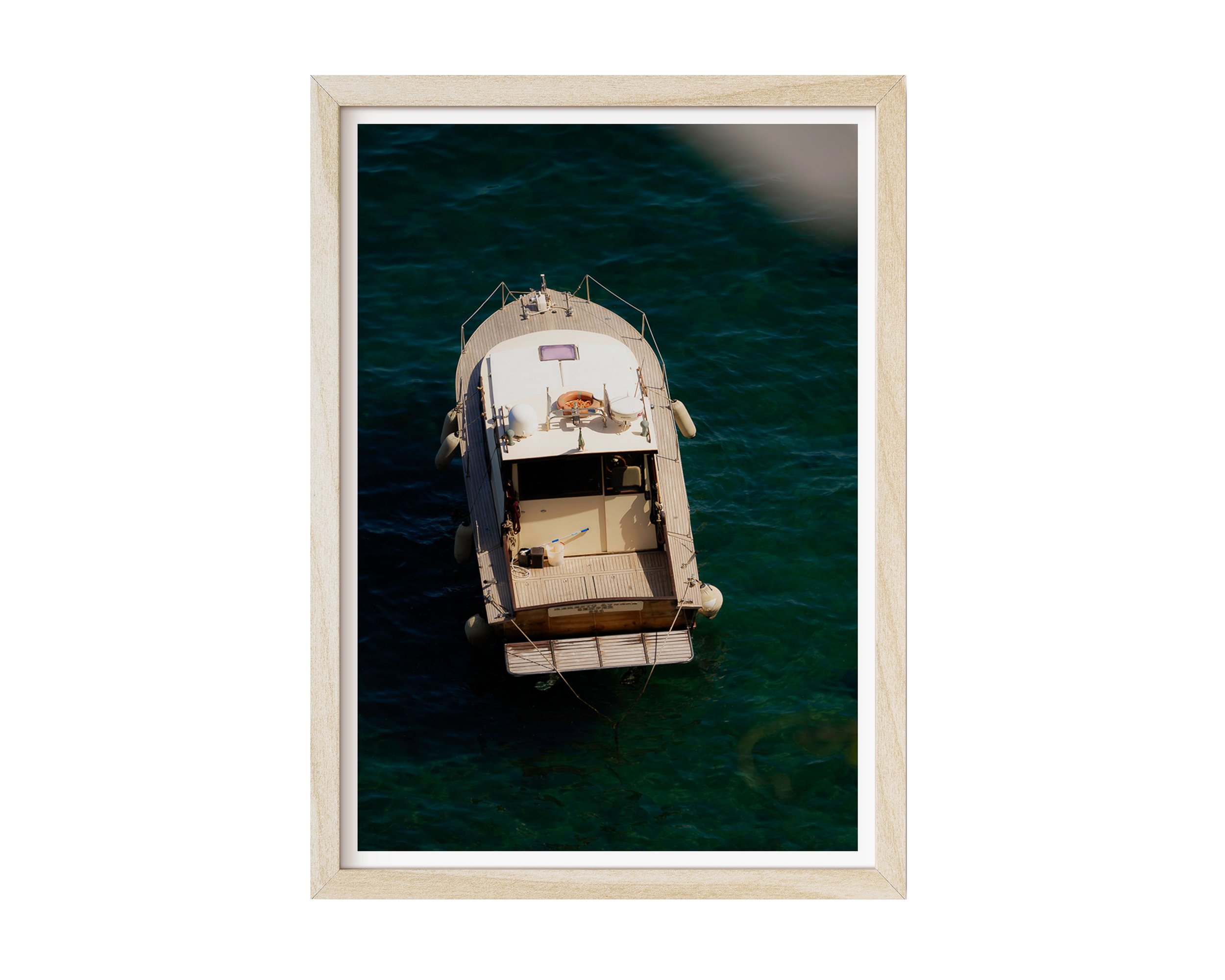 Overhead view of a vintage wooden boat floating in clear turquoise water along the Mediterranean coast, captured in golden sunlight – serene nautical fine art print by Nicole Toland Photography