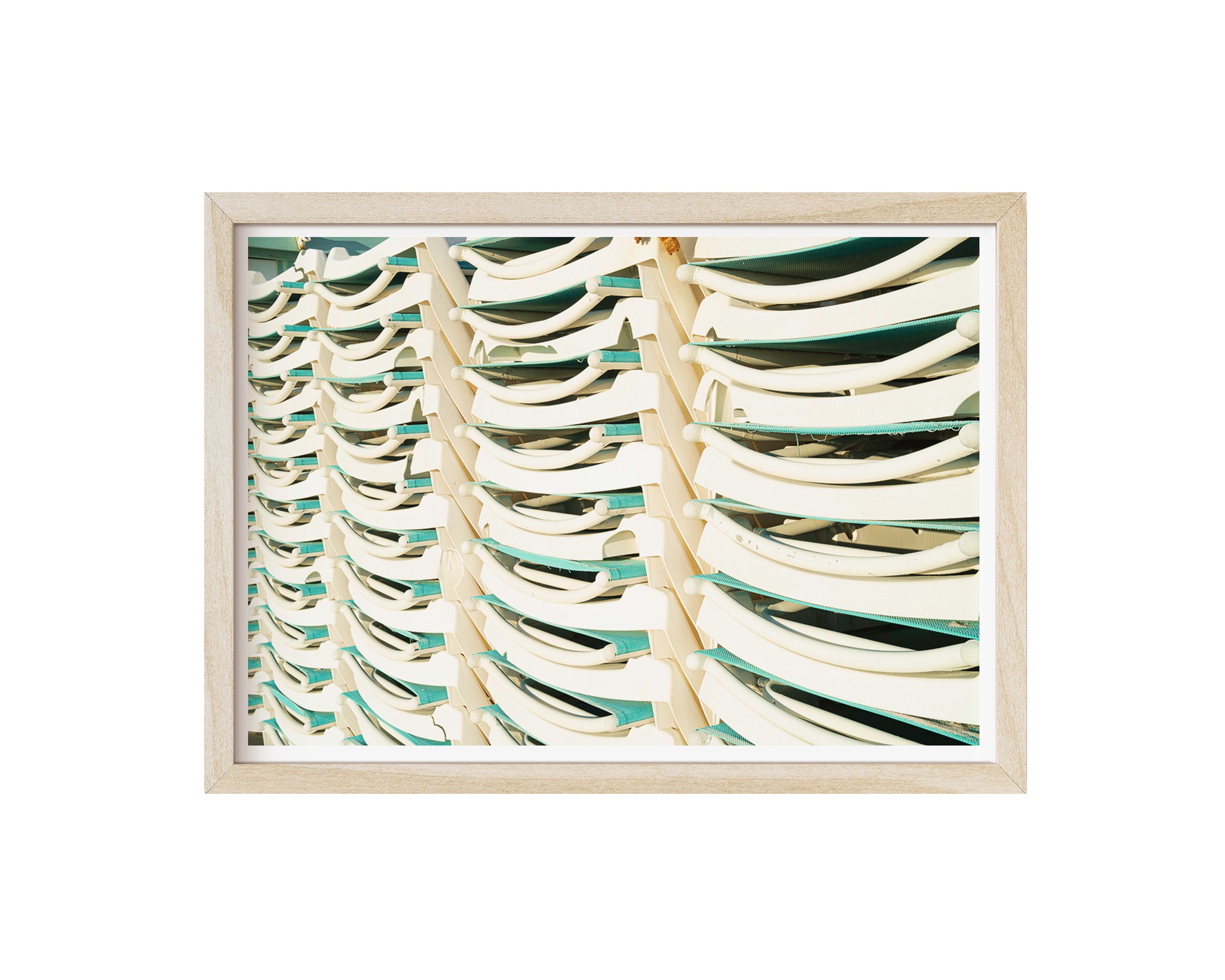 A minimalistic and playful framed fine art print featuring stacked white and teal lounge chairs, bathed in natural sunlight.