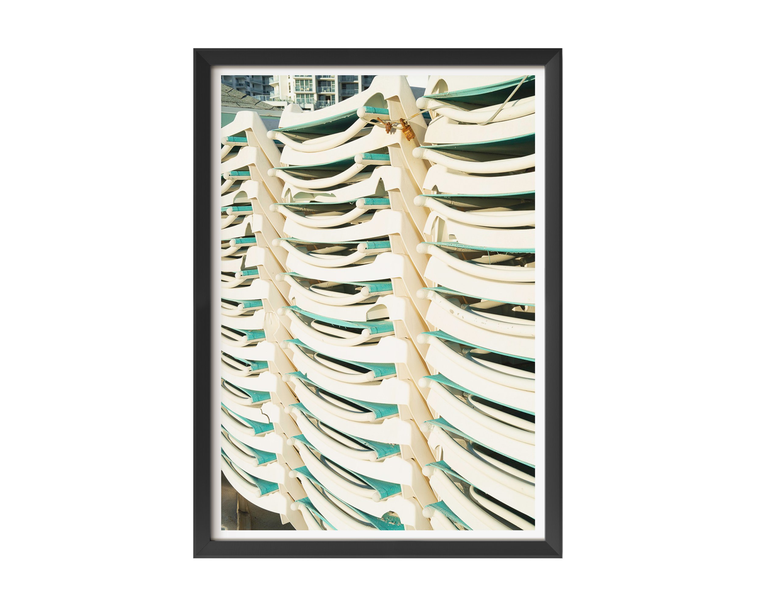 A modern fine art photograph featuring a tightly stacked row of sunlit white and teal lounge chairs, captured with crisp lines and rhythmic repetition.