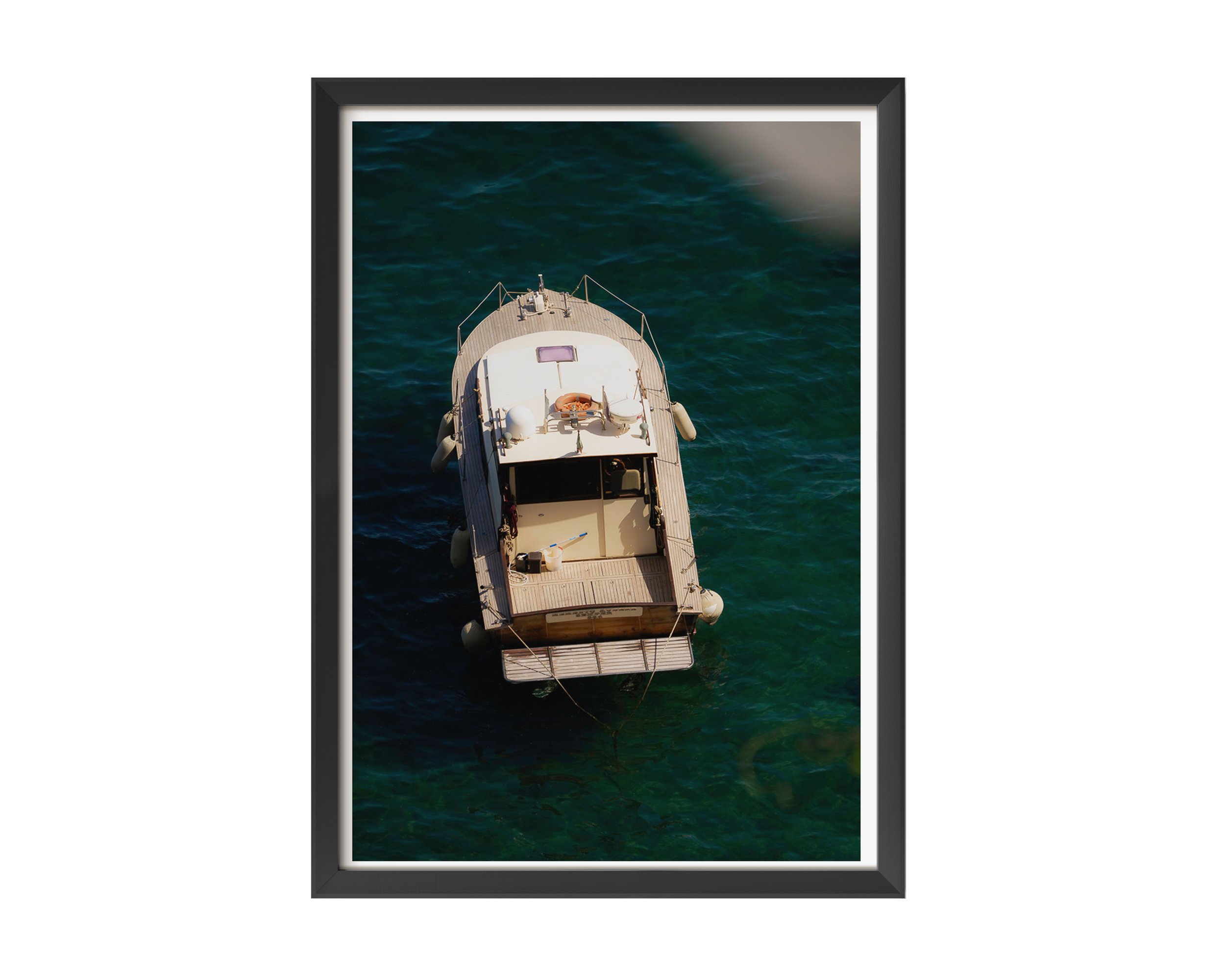 Overhead view of a vintage wooden boat floating in clear turquoise water along the Mediterranean coast, captured in golden sunlight – serene nautical fine art print by Nicole Toland Photography