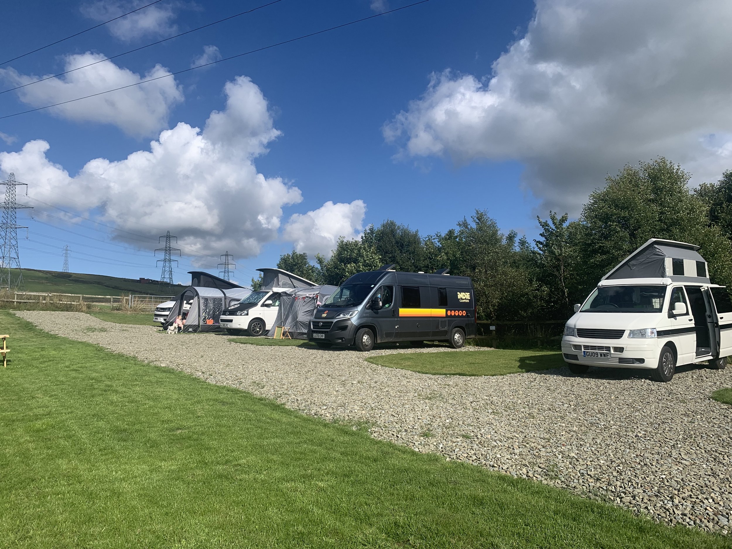A row of campervans making the most of the facilites on a glamping site in lancashire