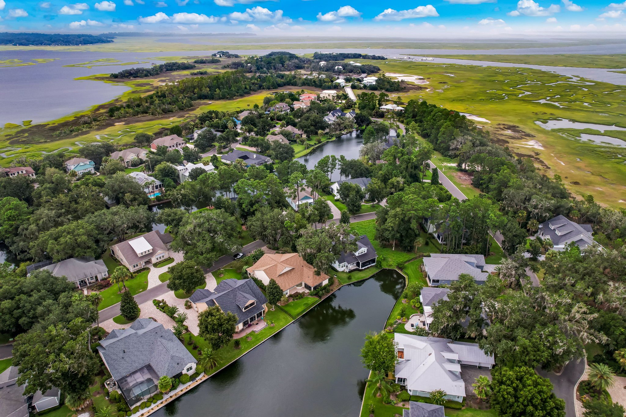 Aerial view of Oyster Bay Harbour homes, lakes and coastal marsh in Fernandina Beach, Florida