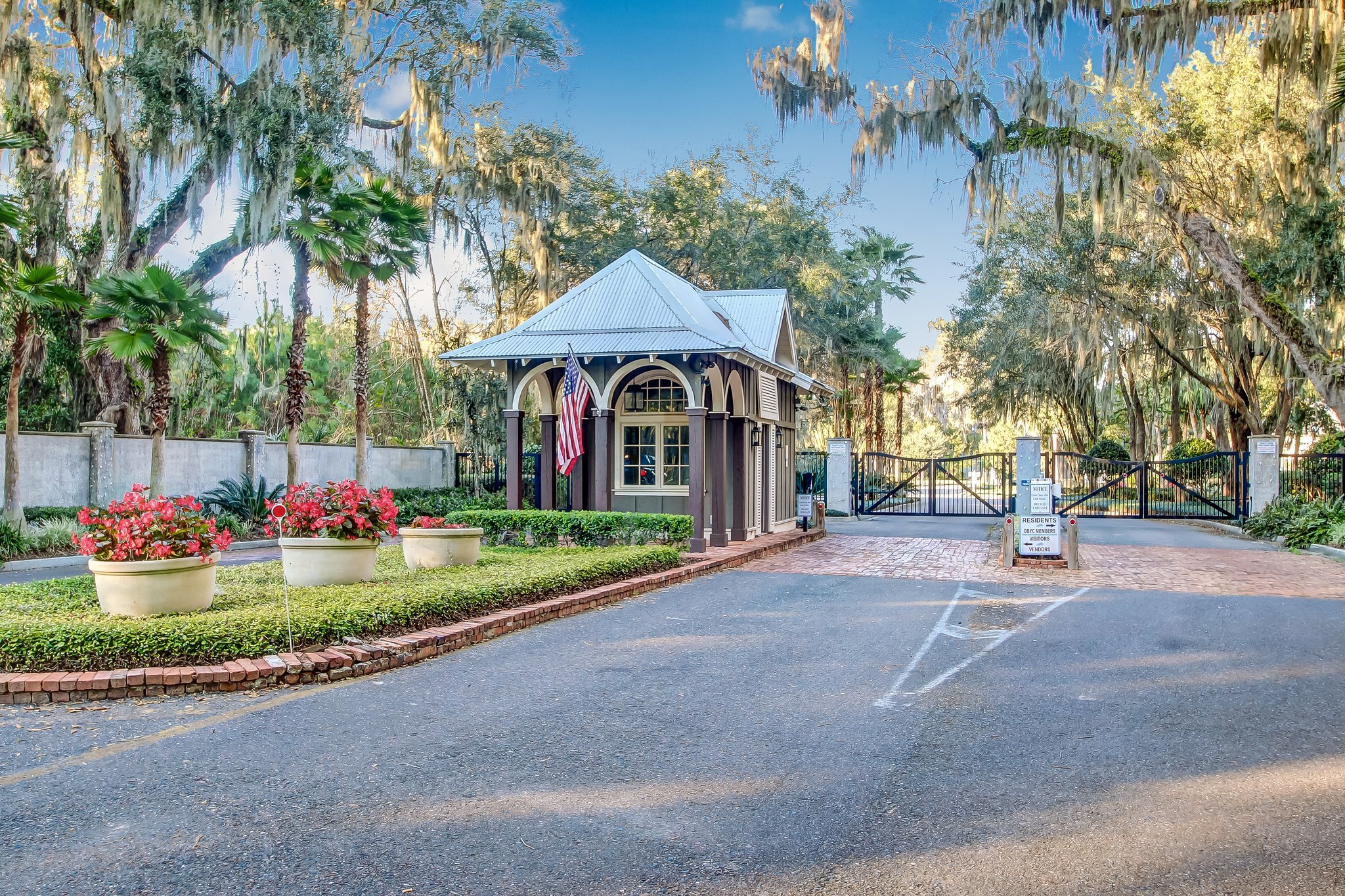 Gated entrance to Oyster Bay Harbour beneath moss-draped oak trees in Fernandina Beach, Florida