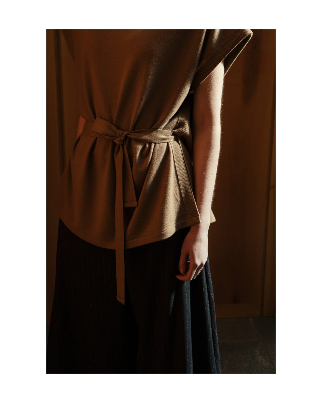 A nod to Japanese-inspired design: cashmere-blend sleeveless top with refined rib accents, and voluminous cropped pinstripe pants.