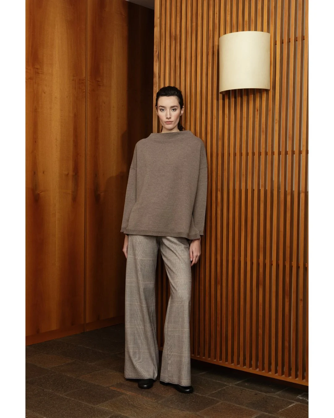 Decisive wide-leg Prince of Wales trousers paired with a cashmere-blend crater-neck sweater. 
Comfort, character, and balance of structure and softness.
