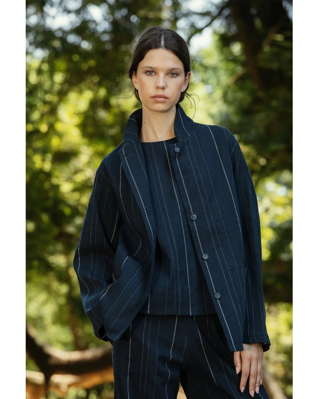 Linen Blend Raw Pinstripe. A deep navy suit with an irregular pinstripe and a subtle Japanese spirit. A raw twill weave adds texture and character to a clean, minimal suit.