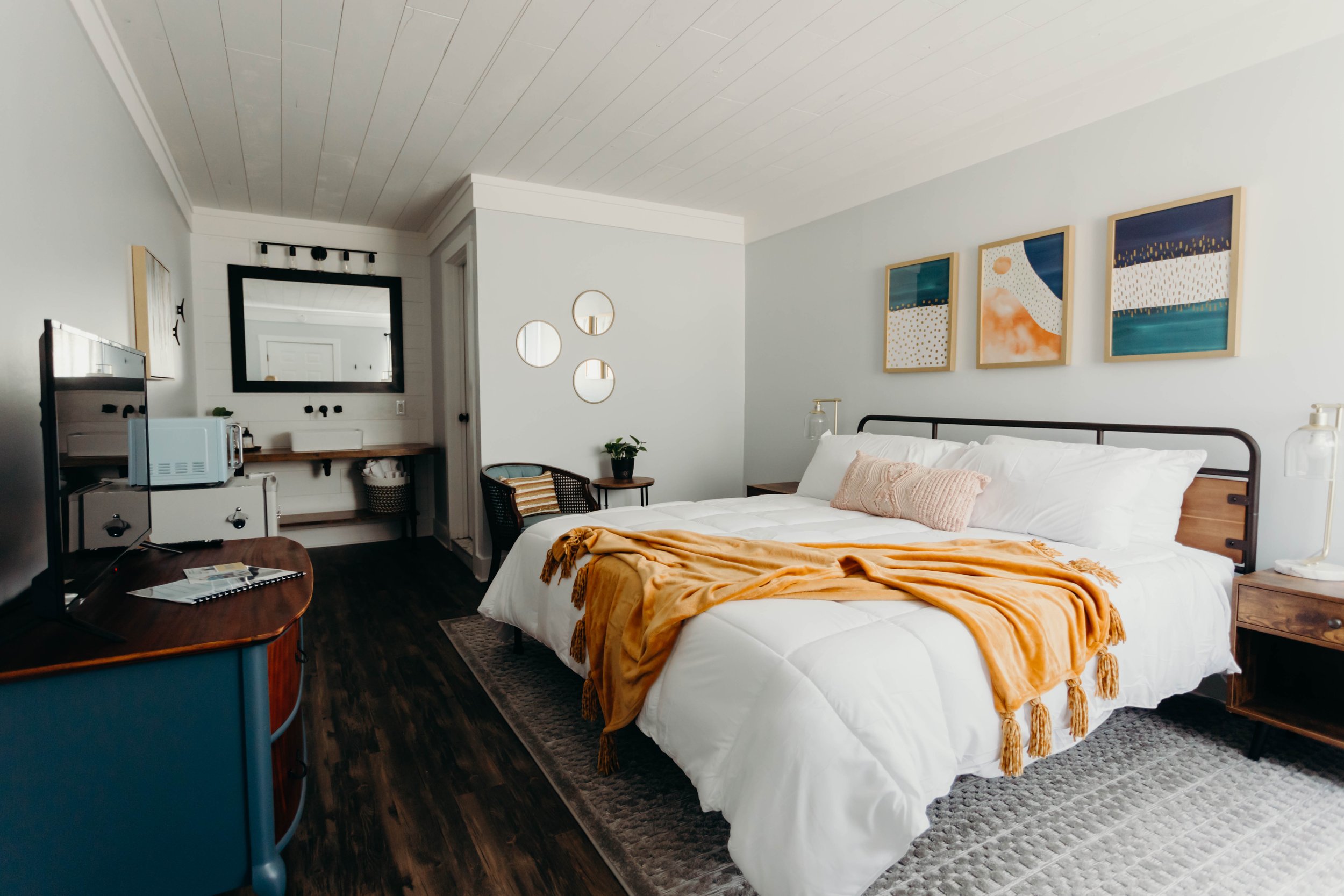 Fully renovated guest room interior featuring contemporary styling, updated lighting, and clean bedding near Dale Hollow Lake.