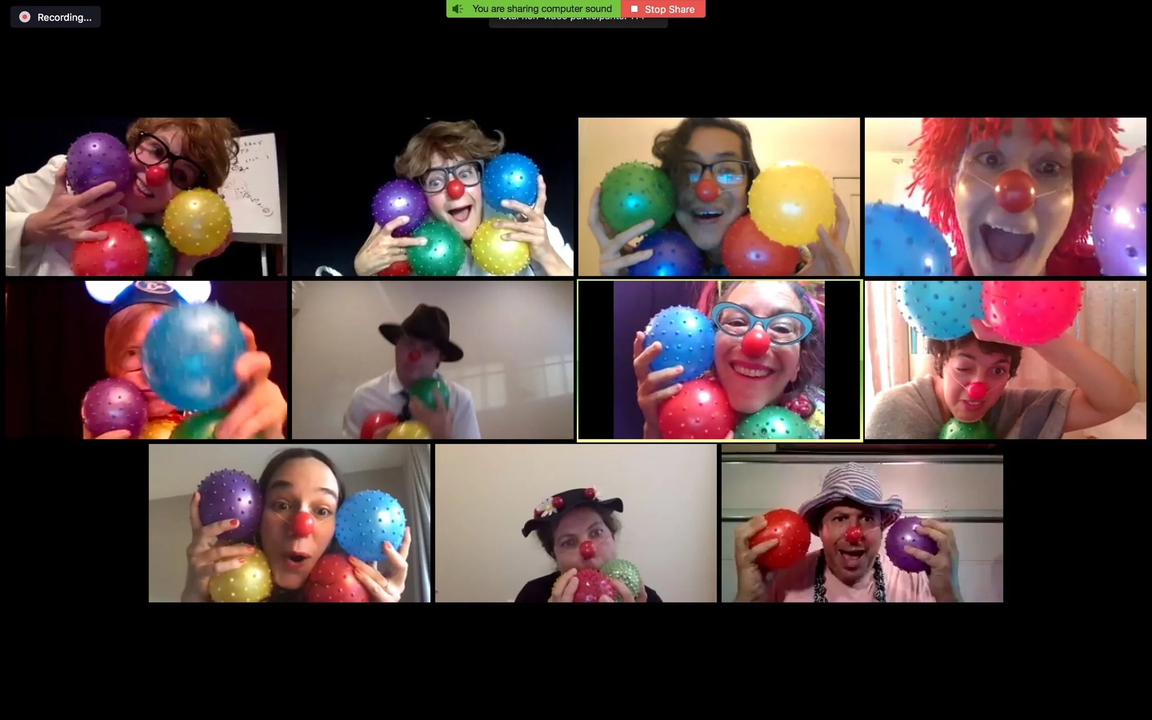 Eleven clowns pose gleefully on Zoom with colorful spiky balls