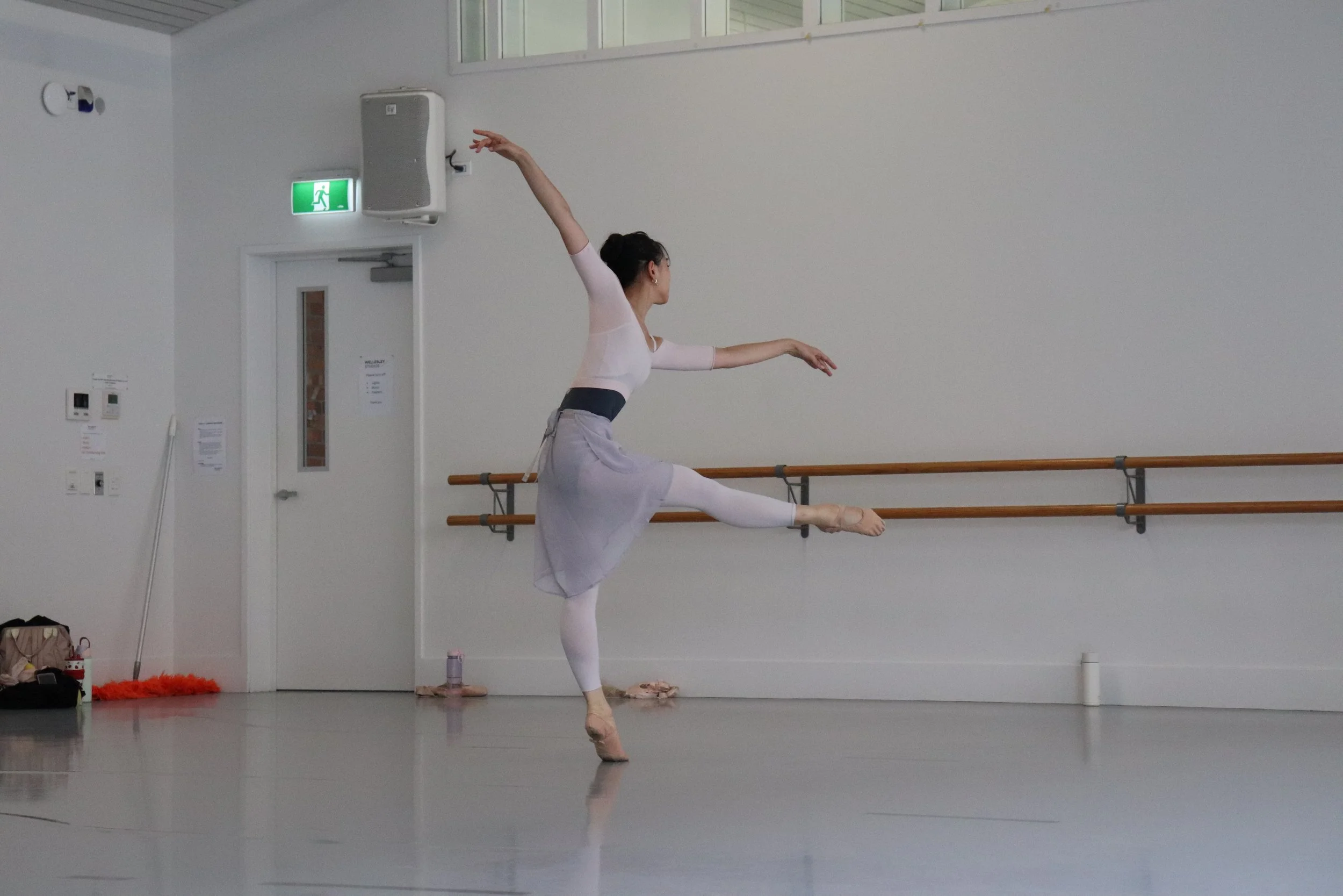 Ballerina performing an off balance low develope devant