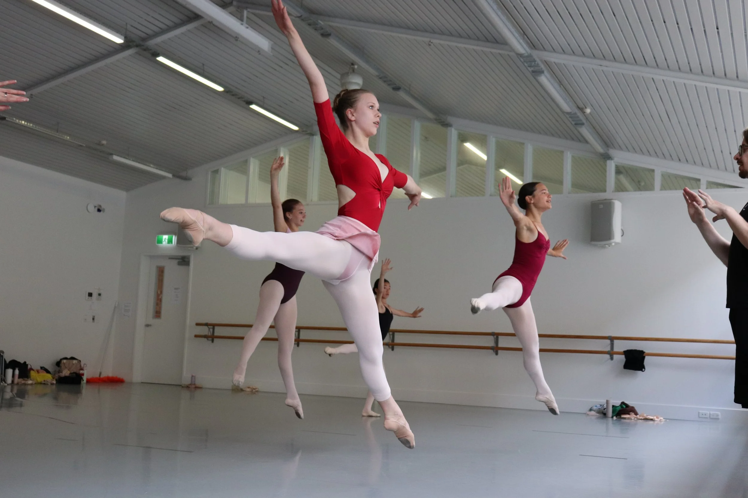 Dancers in large sissonne de cote while learning in Loughlan Prior's repertoire workshop