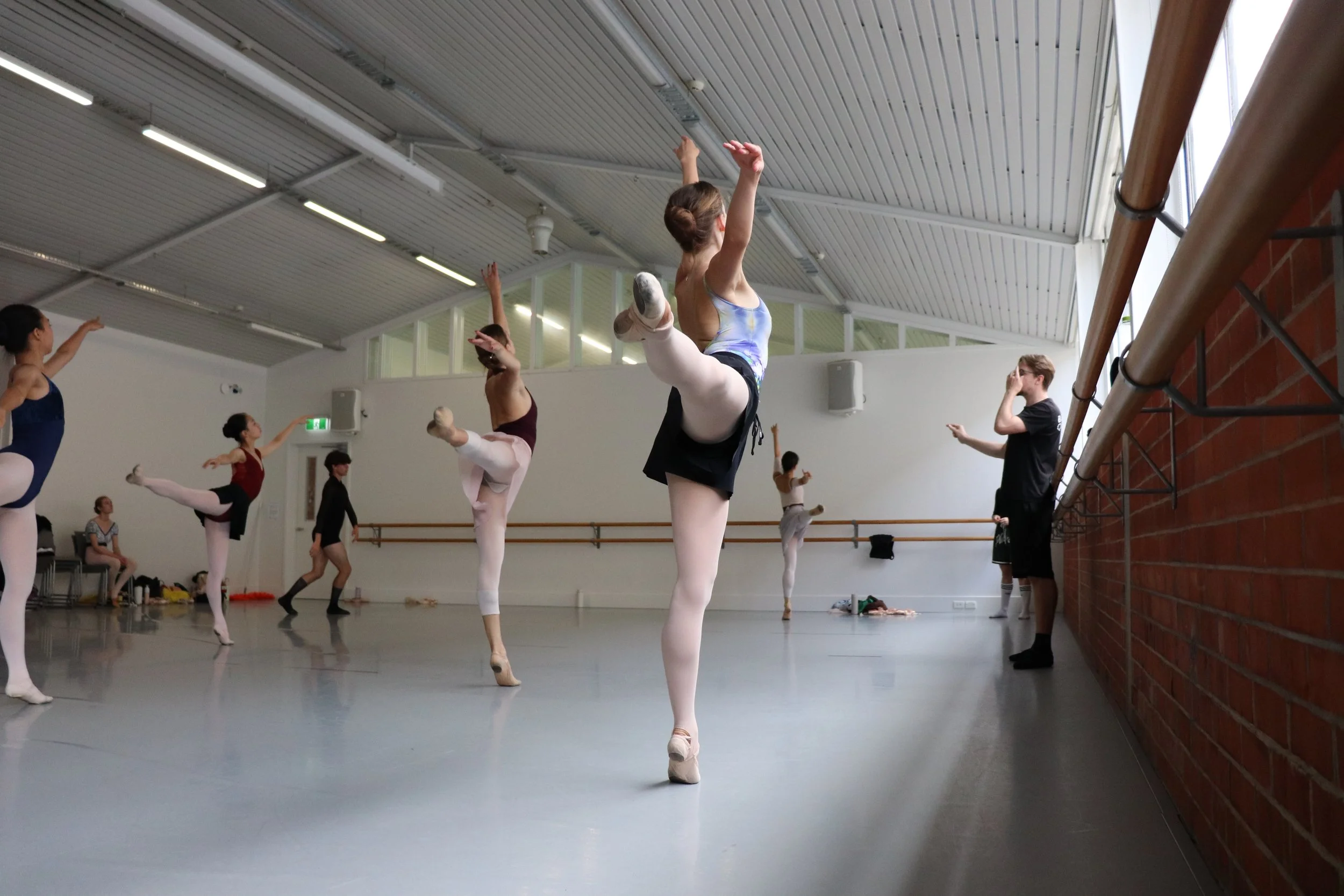 Dancers performing Loughlan Prior's choreography doing an arabesque in unison 