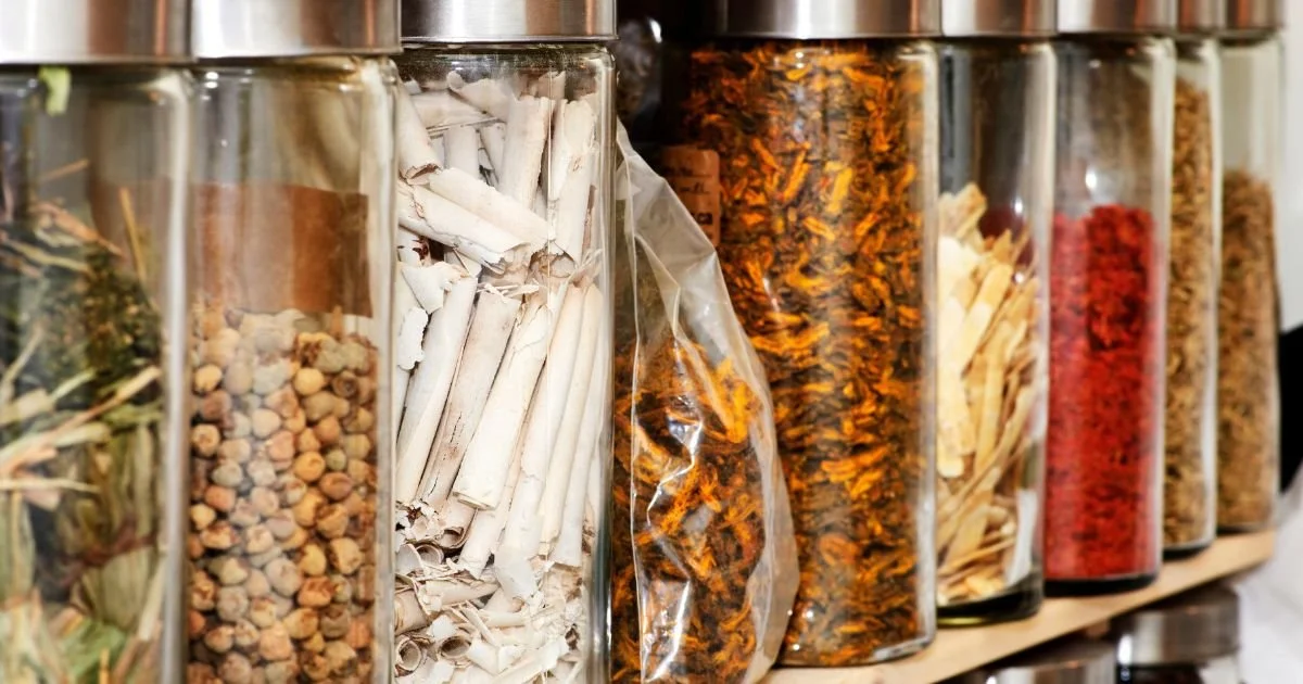 Selection of Chinese herbs used in Traditional Chinese Medicine, stored in large glass jars