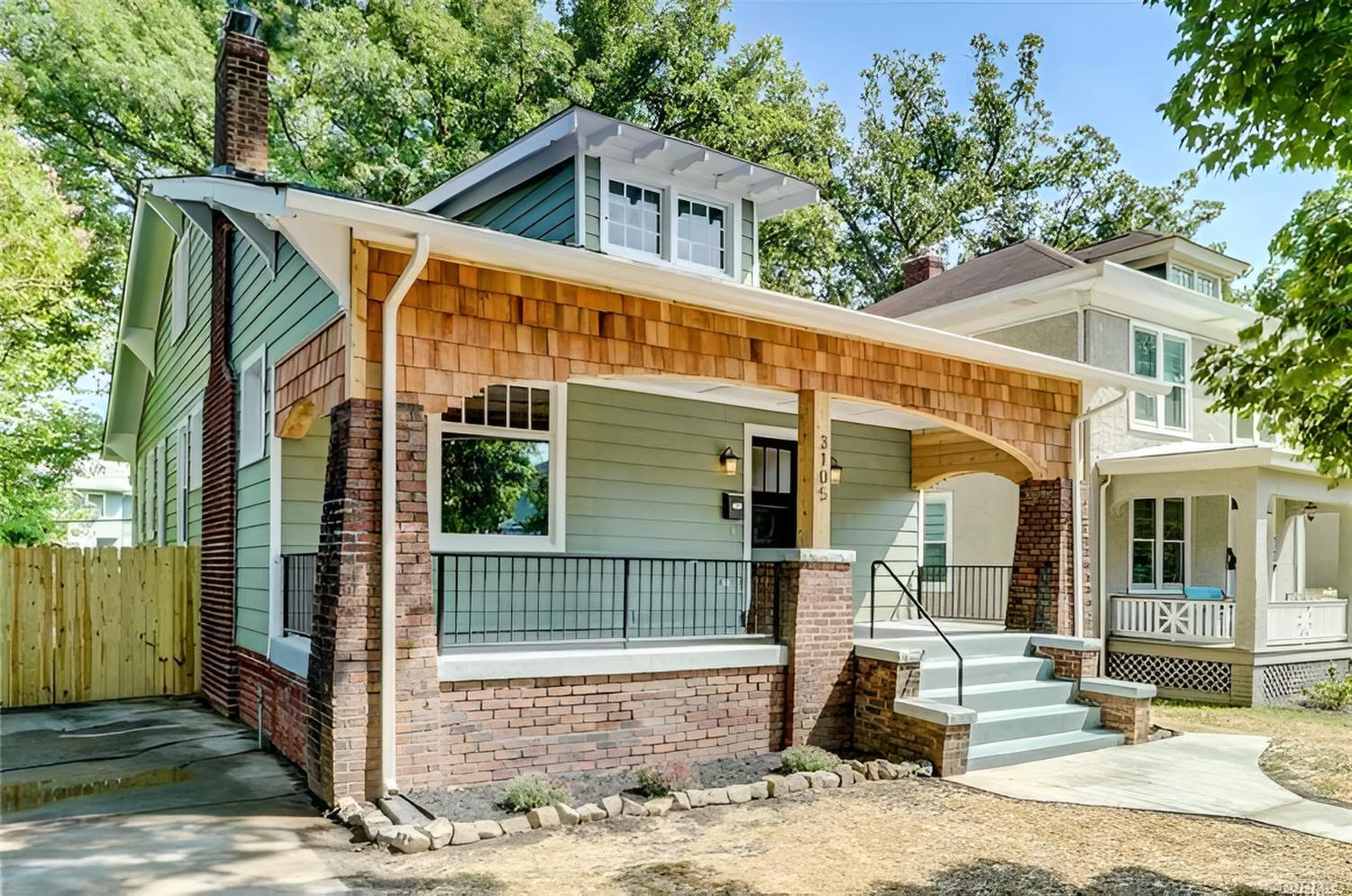 Beautifully restored bungalow with custom railings and cedar shake.
