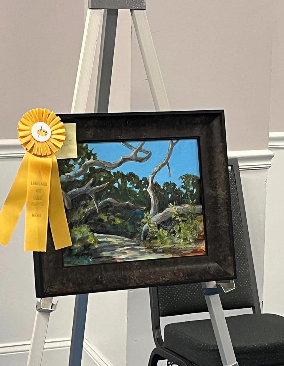 Pleased to announce that this Plein Air "Anastasia State Park" received Merit award from Lakeland Artists Association on display at RP Convention Center Lakeland Florida.
The artwork is a landscape painting depicting a natural scene dominated by tre