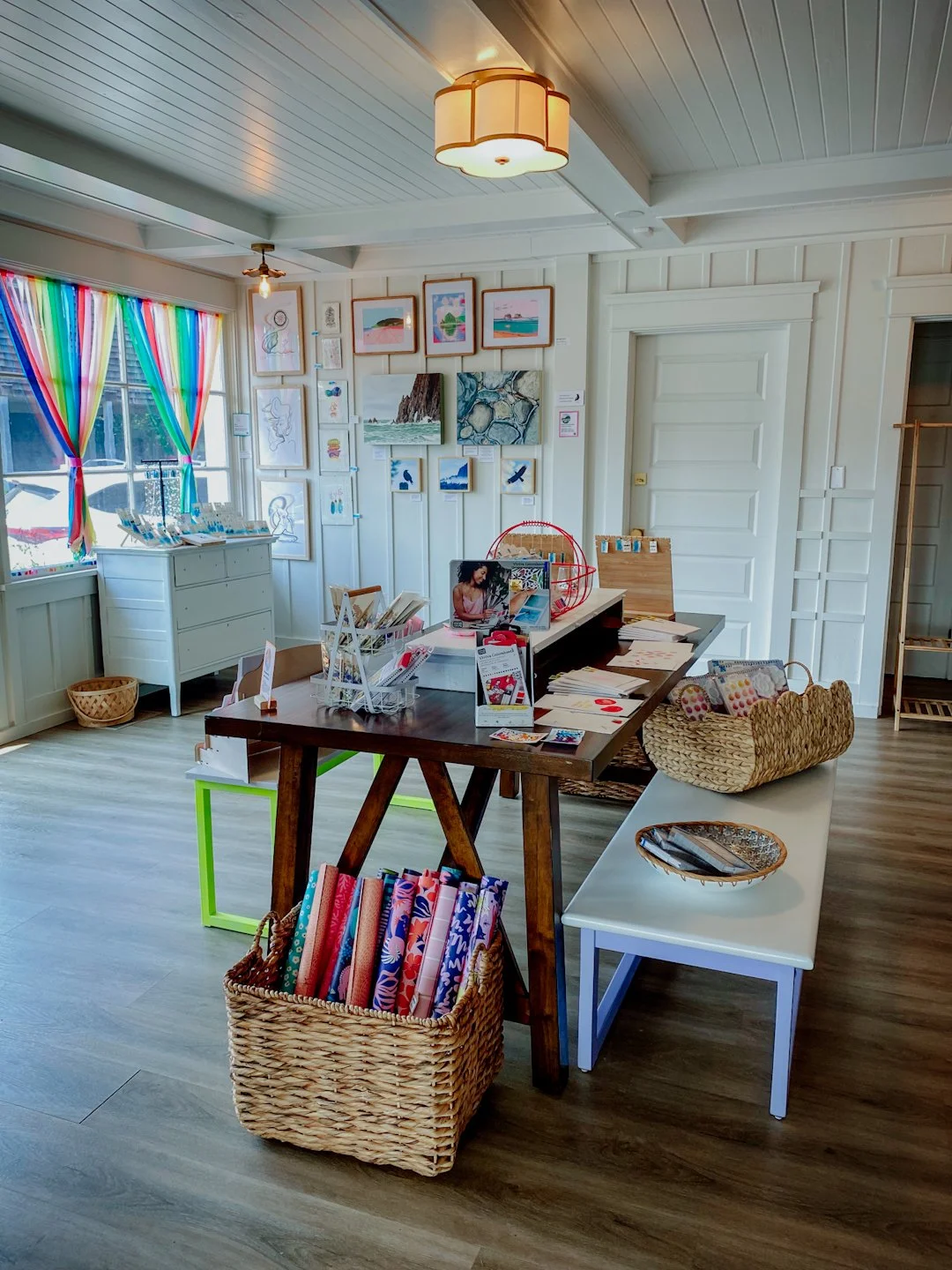 display tables and gallery wall with local art from Manzanita, Oregon. Perch Makers Table: retail shop & creative space.