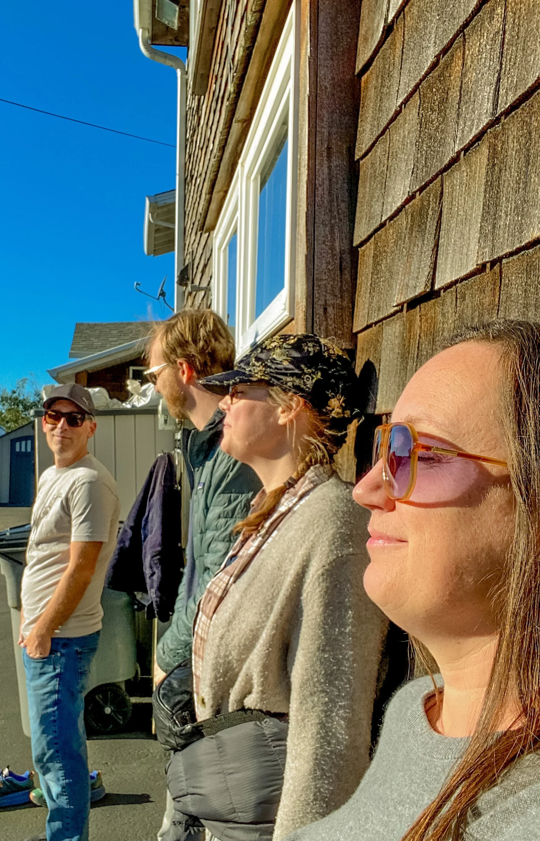 Katie and friends soaking up the sun on their faces on a warm Oregon Coast January day.