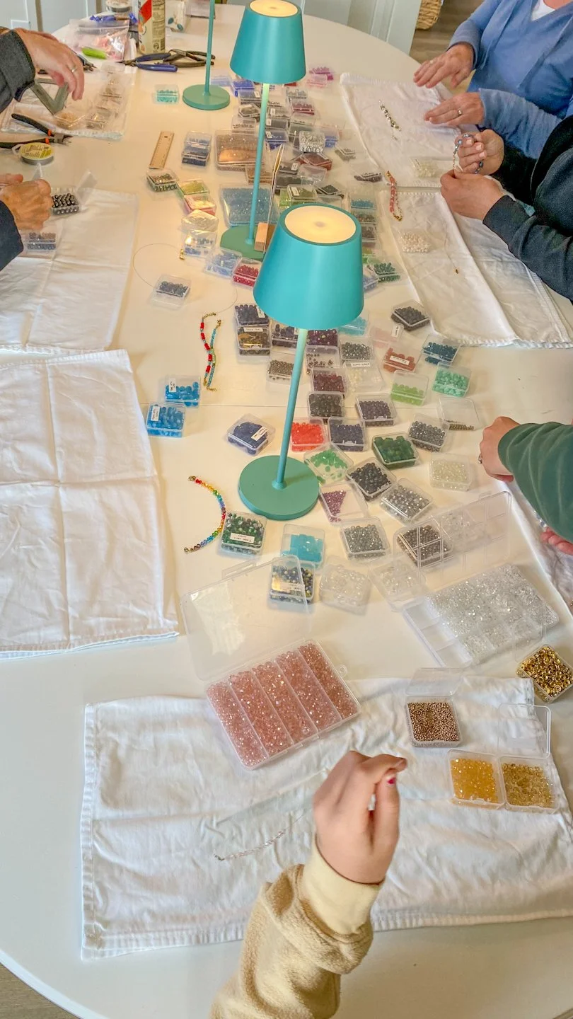 Beads and bracelet making happening by individuals at Perch Makers Table
