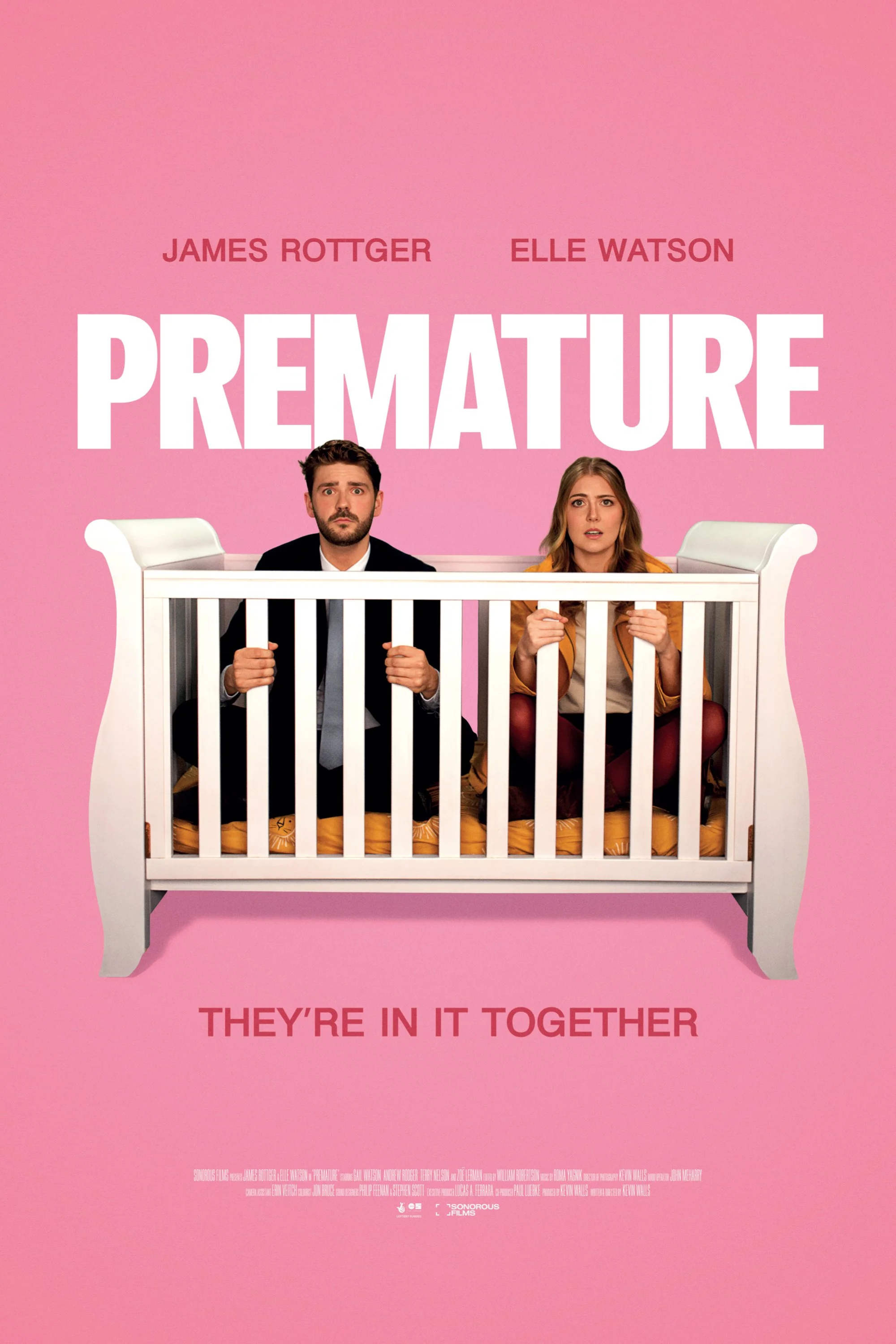 Movie poster for 'Premature' featuring two people sitting in a baby crib against a pink background, with the tagline "They're in it together."