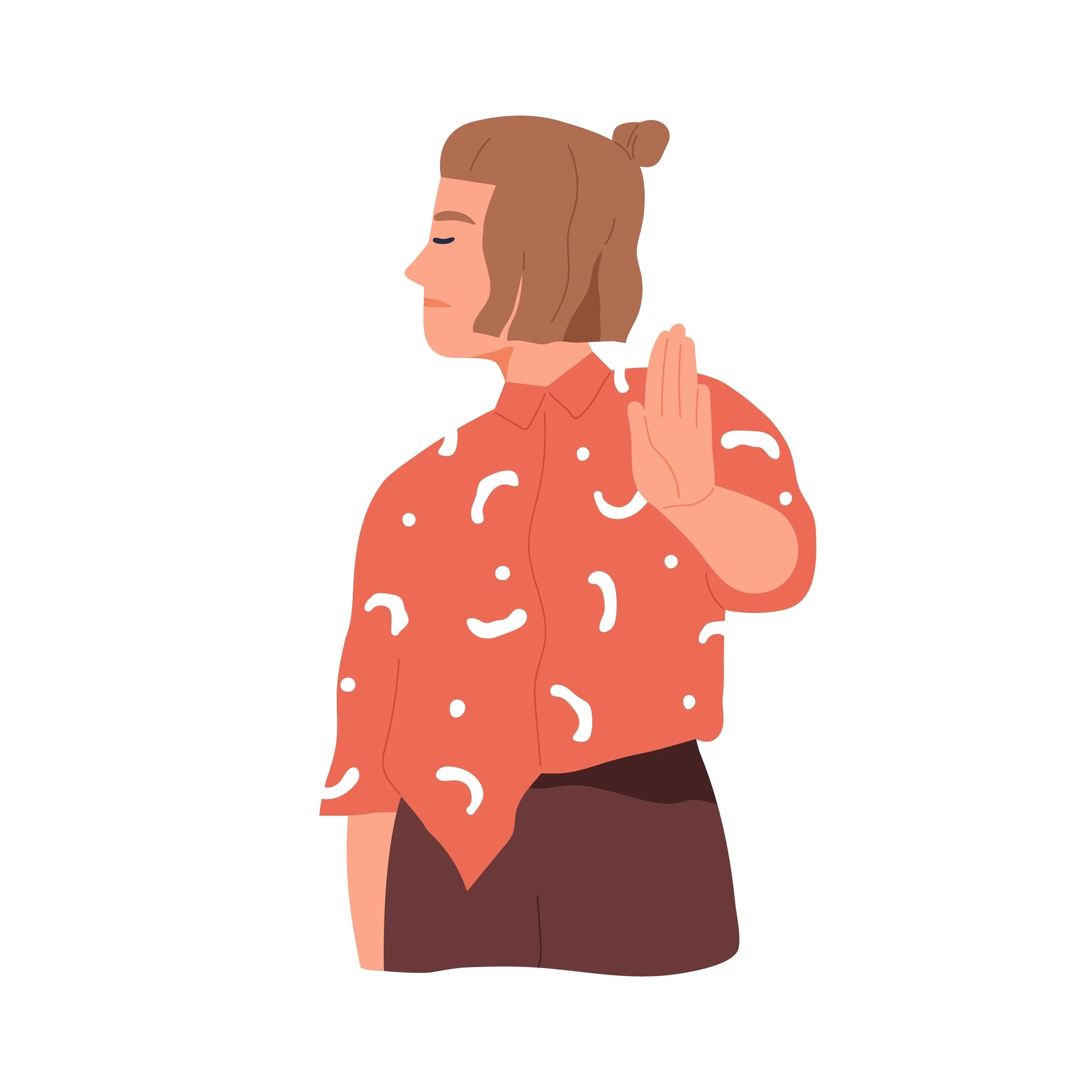 A woman with brown hair tied in a bun wearing a red shirt with white patterns, holding up her right hand in a gesture to stop or signal 'no'.