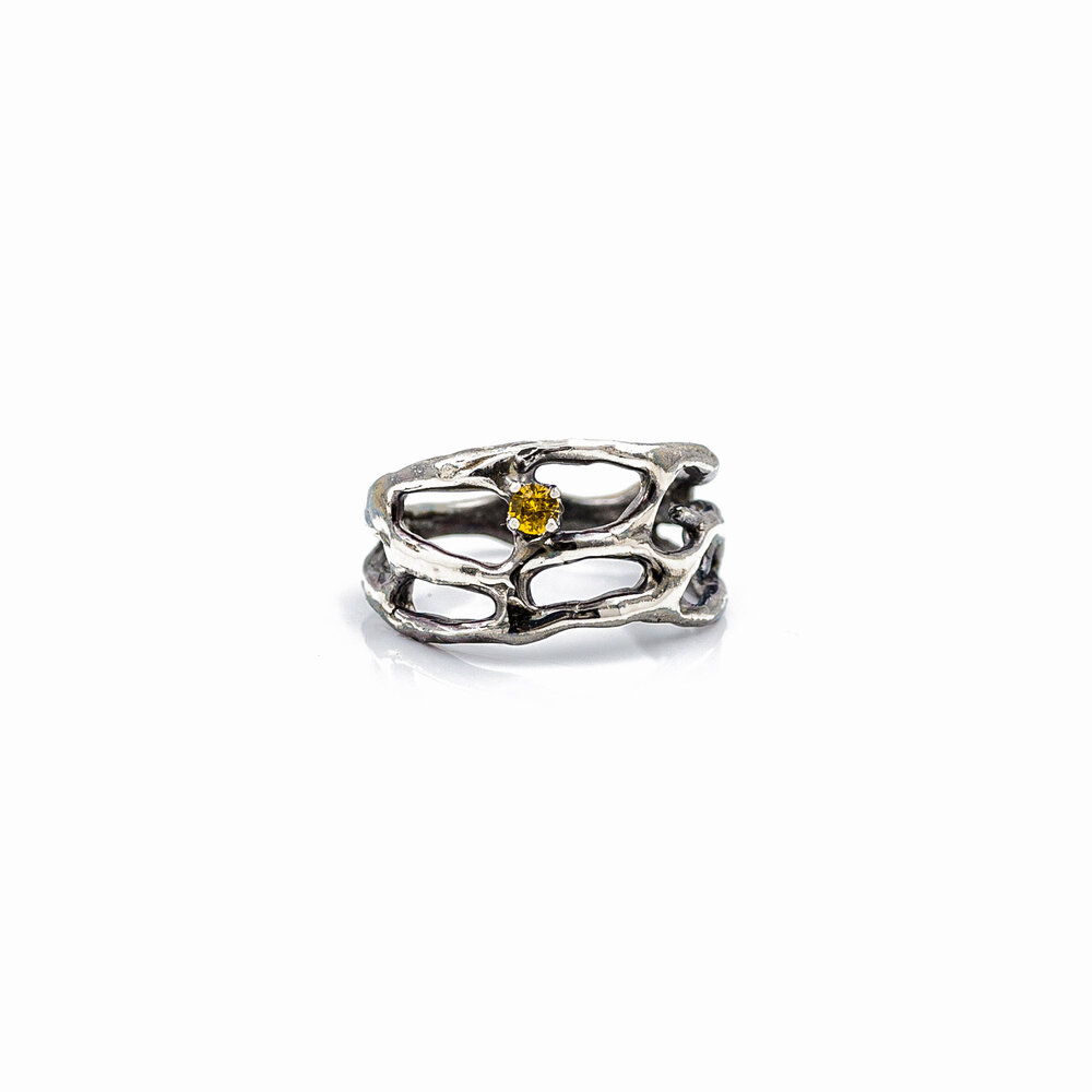 Silver branches of a Cajal ring surround a stunning yellow Australian sapphire. Luke Maninov